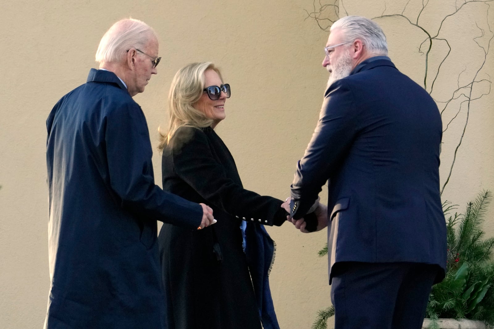 President Joe Biden and first lady Jill Biden are greeted as they arrive at St. Joseph on the Brandywine Catholic Church in Wilmington, Del., on Wednesday, Dec. 18, 2024. Wednesday marks the 52nd anniversary of the car crash that killed Joe Biden's first wife Neilia Hunter Biden and 13-month-old daughter Naomi. (AP Photo/Ben Curtis)