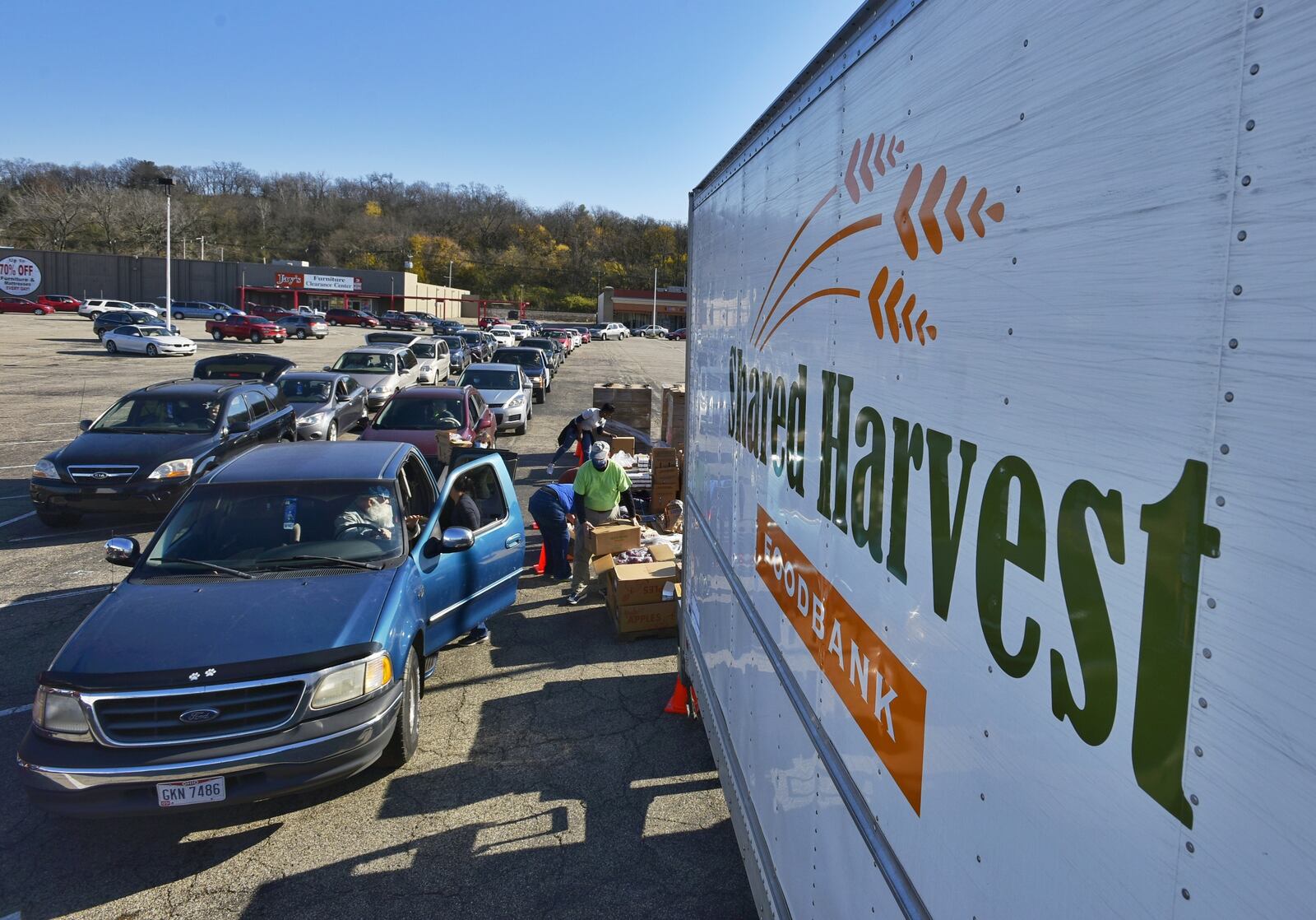 More than 100 cars lined up in Hamilton Friday to receive free food boxes as part of senior program sponsored by Shared Harvest food bank in Fairfield. More than 300 seniors who had signed up for the food giveaway came through the distribution center set up in a shopping center parking lot along Route 4 in Hamilton. (Photo By Nick Graham\Journal-News)