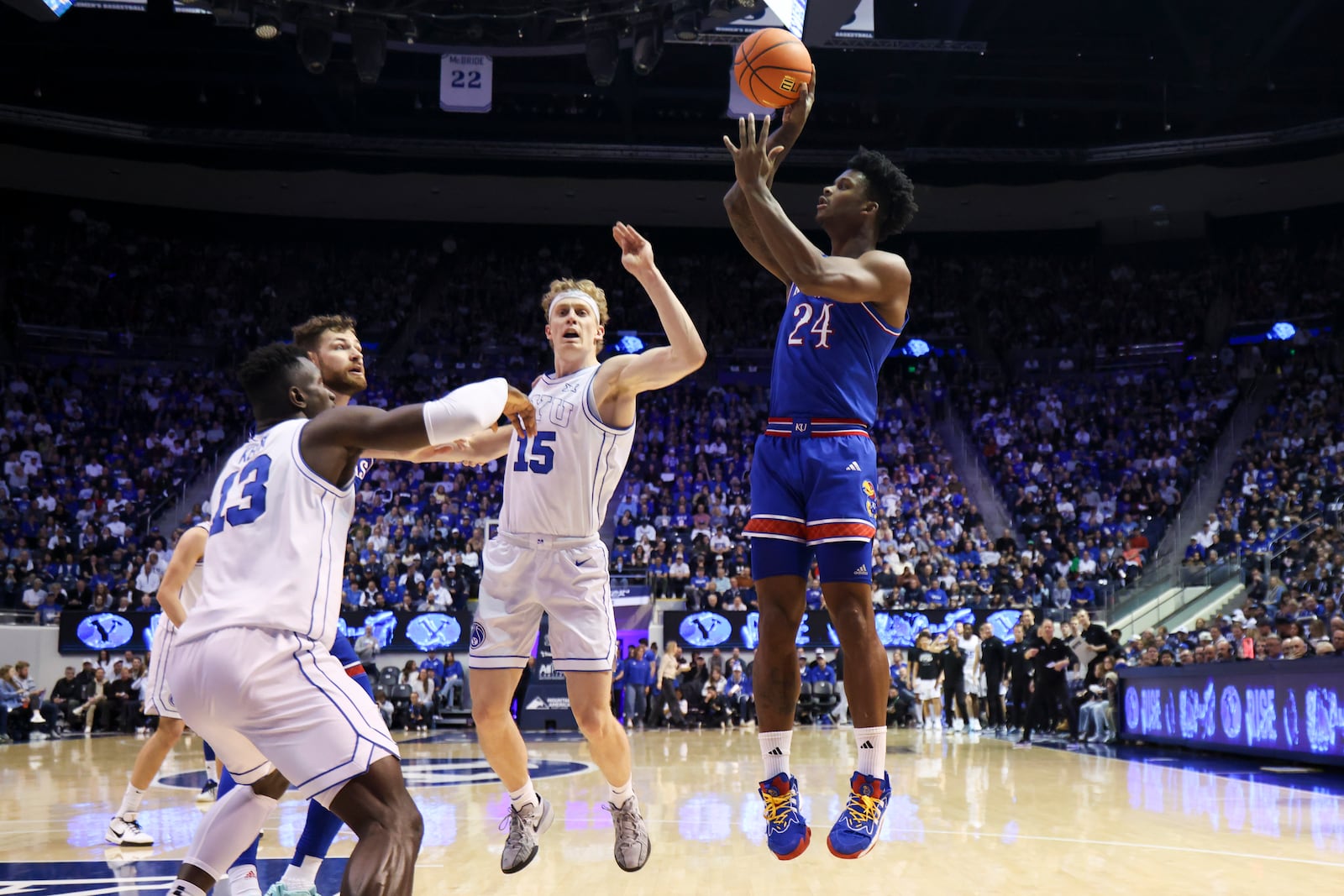 Kansas forward KJ Adams Jr. (24) shoots over BYU forward Richie Saunders (15) and center Keba Keita (13) during the second half of an NCAA college basketball game, Tuesday, Feb. 18, 2025, in Provo, Utah. (AP Photo/Rob Gray)