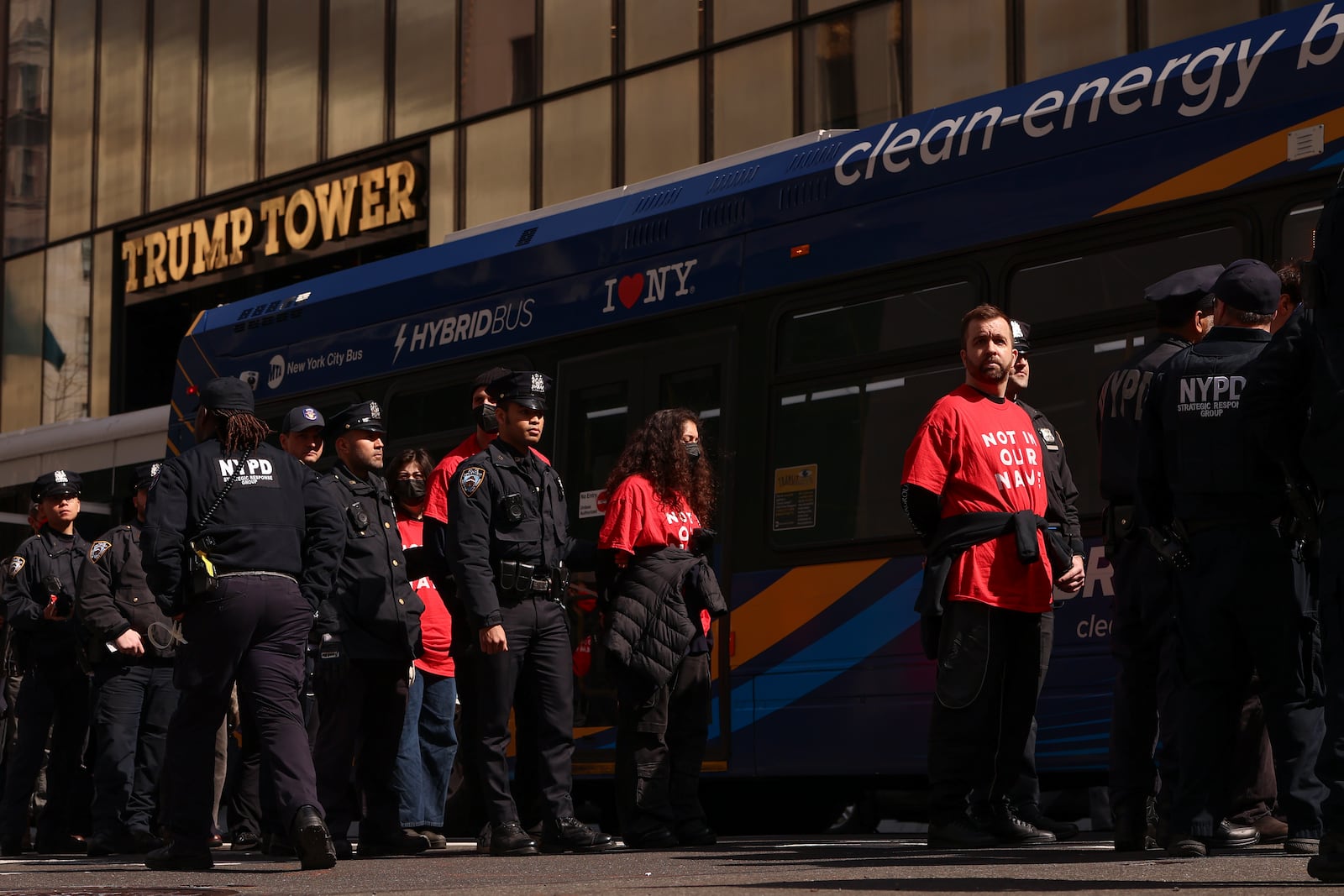 Demonstrators from the group, Jewish Voice for Peace, who were arrested while protesting inside Trump Tower, wait to board a bus escorted by New York Police officers, Thursday, March 13, 2025, in New York. (AP Photo/Yuki Iwamura)