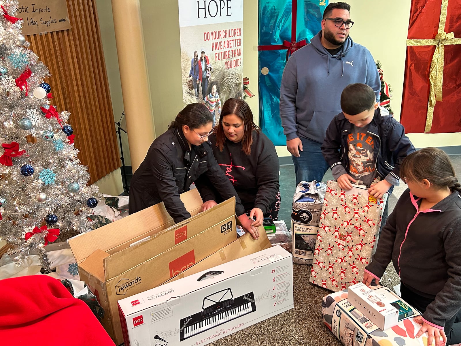 Jean and Katiria DeJesus and their three children, Amaya, 11, Anais, 9, and Dylan, 6, received presents Thursday afternoon from Walmart and the Middletown Salvation Army. RICK McCRABB/STAFF