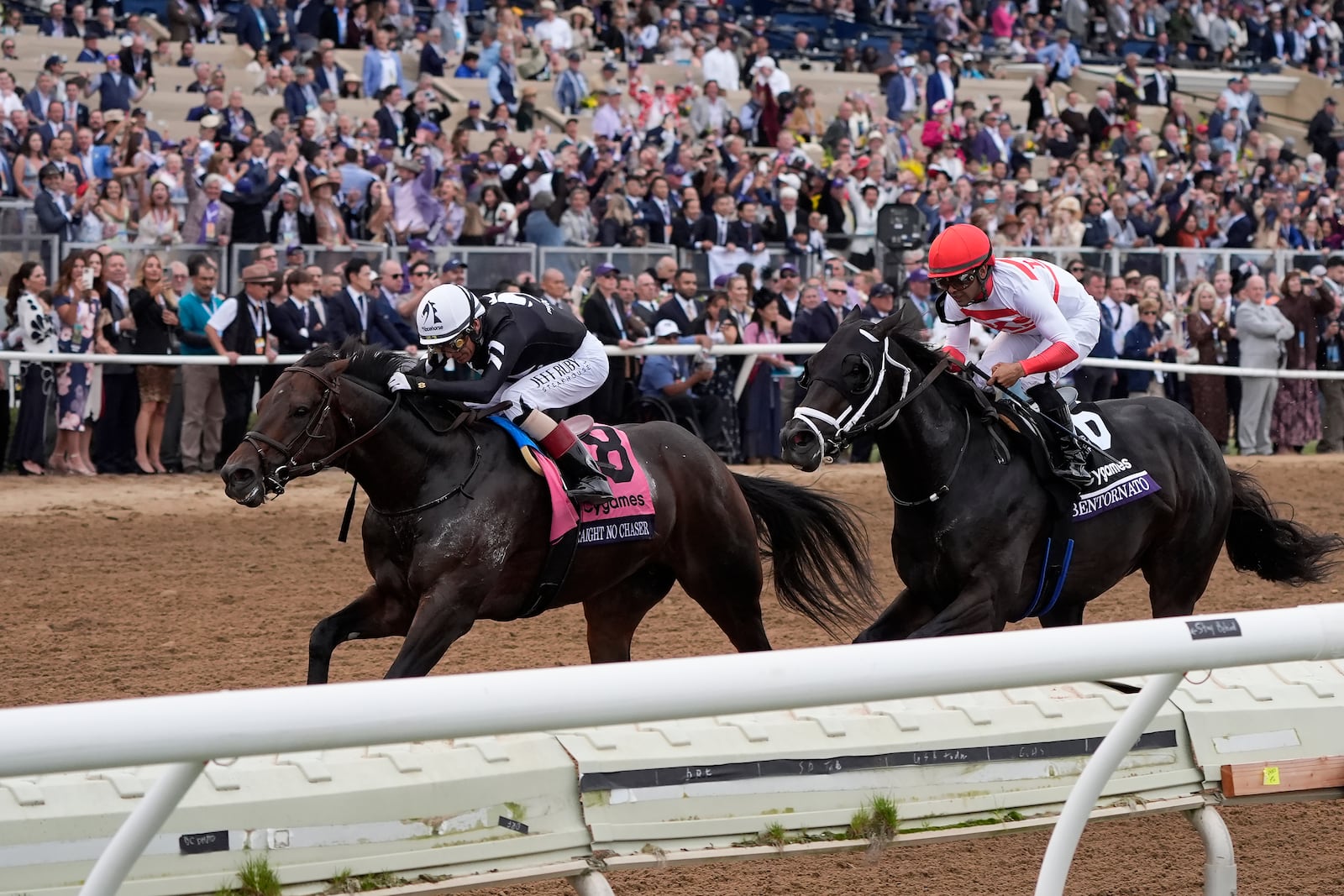 John Velazquez rides Straight No Chaser, left, to victory past Luis Saez, riding Bentornato, in the Breeders' Cup Sprint horse race in Del Mar, Calif., Saturday, Nov. 2, 2024. (AP Photo/Gregory Bull)