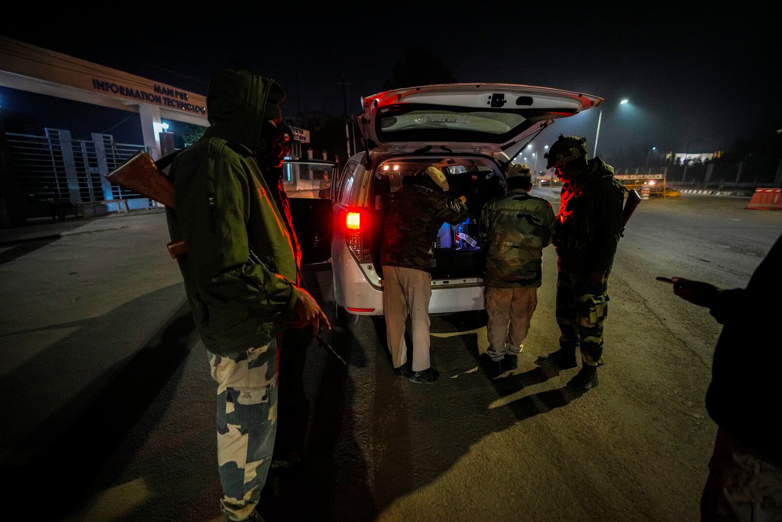 Security personnel check vehicles in Imphal, Manipur, Sunday, Dec. 15, 2024. (AP Photo/Anupam Nath)