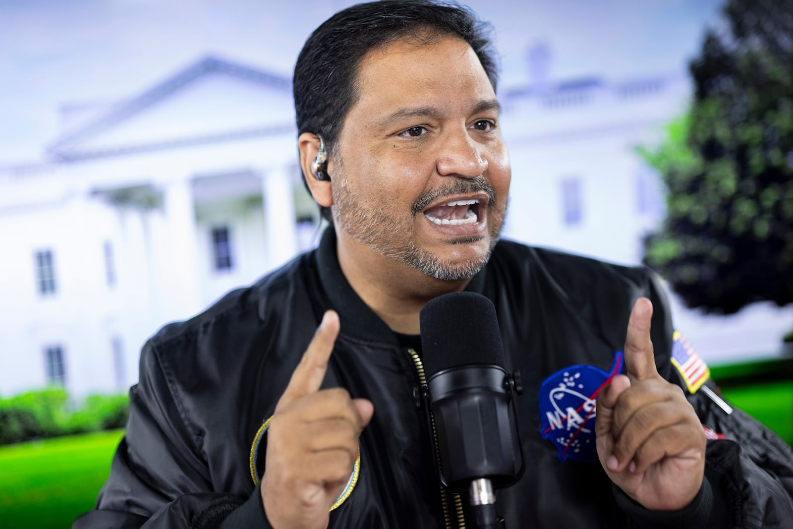 Radio host and owner of radio station La Mega 101.7 FM Victor Martinez on the air in Allentown, Pa, Tuesday, Oct. 15, 2024. (AP Photo/Ryan Collerd)