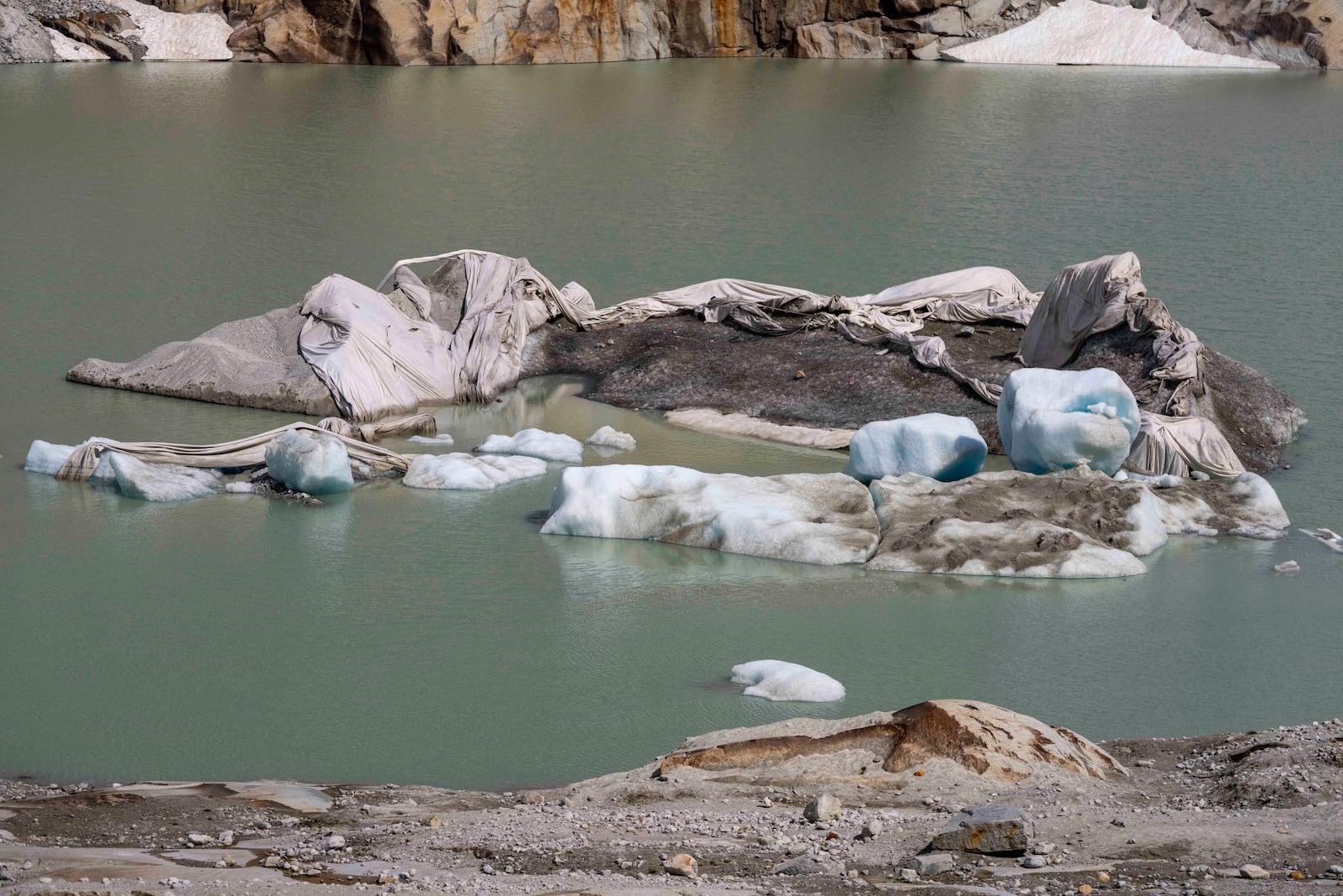 FILE - Chunks of ice float in a lake in front of Rhone Glacier near Goms, Switzerland, June 15, 2023. (AP Photo/Matthias Schrader, File)