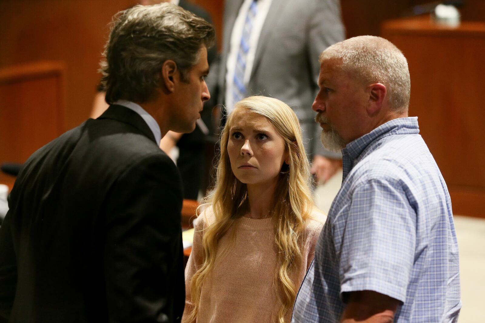 Brooke “Skylar” Richardson, center, talks with defense attorney Charles M. Rittgers, left, and her father, Scott, right, in the courtroom at the conclusion of the day’s proceedings, Thursday, Sept. 5, 2019, in Warren County Judge Donald Oda’s II courtroom at Warren County Common Pleas Court in Lebanon, Ohio. Richardson, 20, is accused of killing and burying her baby in the backyard of her Carlisle home. Richardson is charged with aggravated murder, involuntary manslaughter, gross abuse of a corpse, tampering with evidence and child endangerment in the death of her newborn infant. She faces the possibility of life in prison.