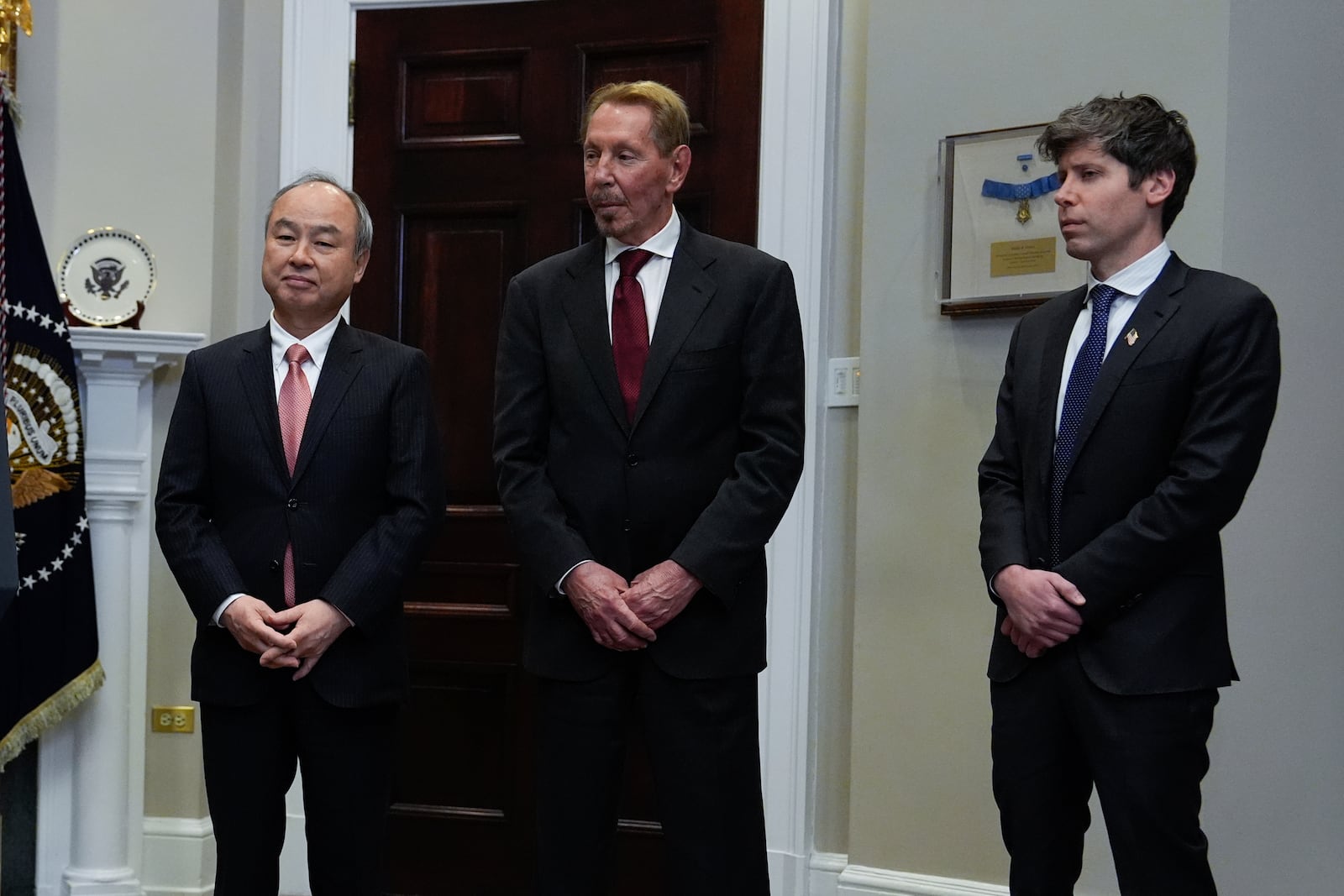 Masayoshi Son, SoftBank Group CEO, from left, Larry Ellison, chairman of Oracle Corporation and chief technology officer, and Sam Altman, OpenAI CEO listen to President Donald Trump in the Roosevelt Room at the White House, Tuesday, Jan. 21, 2025, in Washington. (AP Photo/Julia Demaree Nikhinson)