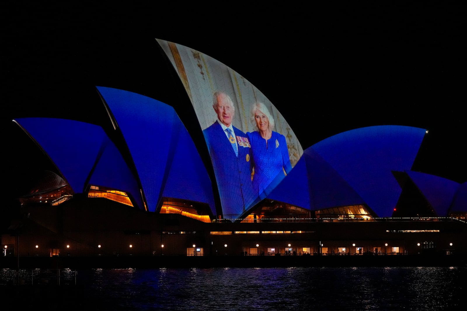 The Sydney Opera House sails show photos of Britain's King Charles and Queen camilla soon after their arrival in Sydney, Australia, Friday, Oct. 18, 2024. (AP Photo/Mark Baker)