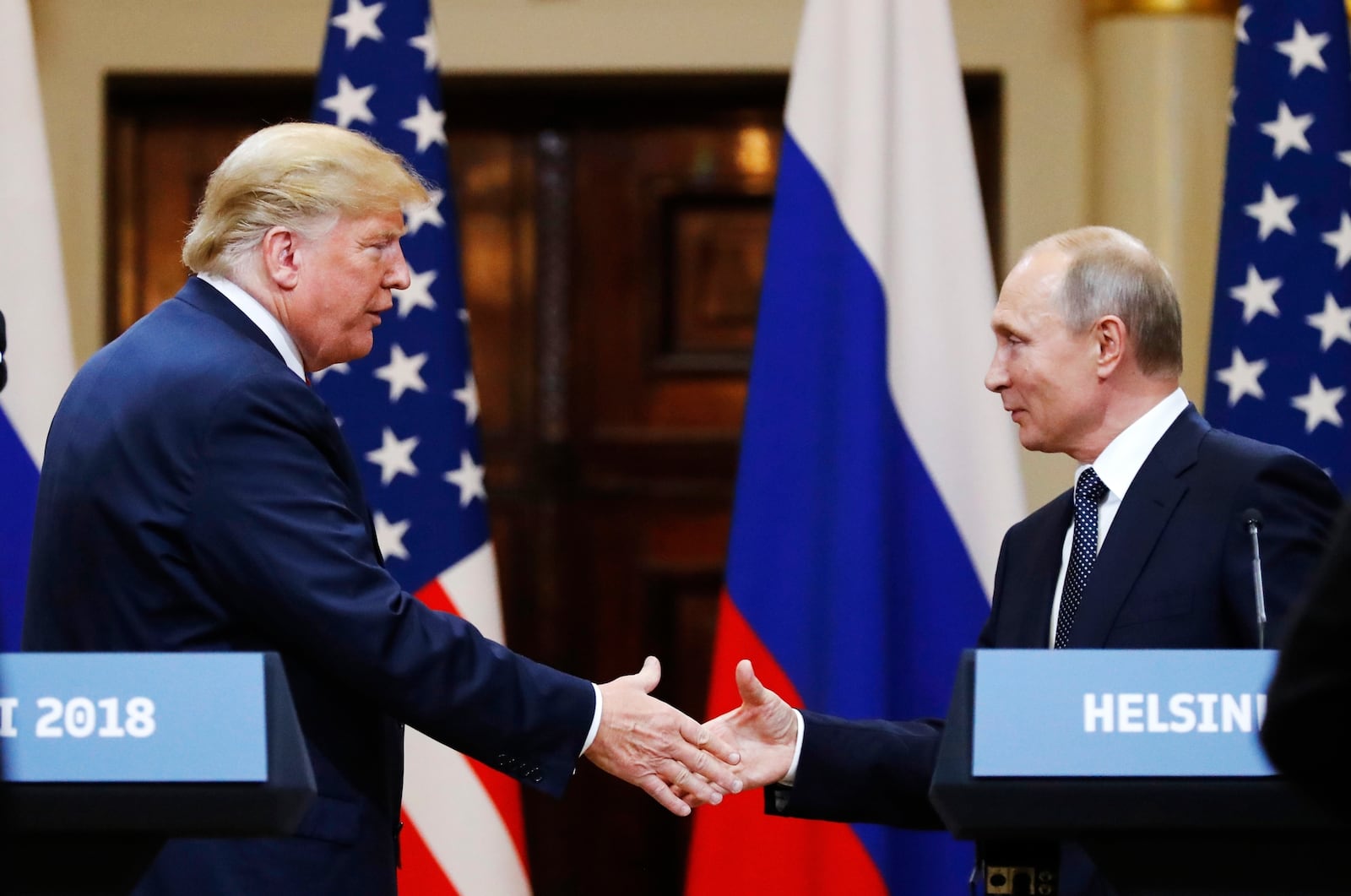 FILE - In this file photo taken on Monday, July 16, 2018, U.S. President Donald Trump shakes hand with Russian President Vladimir Putin at the end of the press conference after their meeting at the Presidential Palace in Helsinki, Finland. (AP Photo/Alexander Zemlianichenko, File)