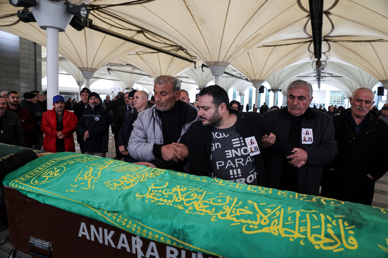 Relatives and friends attend the funeral of Yilmaz Saritas and his children Nehir and Doruk, who were among the 76 victims who died in a fire at the Kartalkaya ski resort in Bolu province, at Karsıyaka cemetery in Ankara, Wednesday, Jan. 22, 2025. (Ugur Yildirim/Dia Photo via AP)