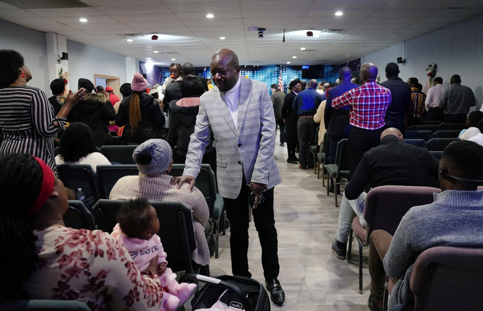 Rev. Reginald Silencieux greets congregants during a service at the First Haitian Evangelical Church of Springfield, Sunday, January 26, 2025, in Springfield, Ohio. (AP Photo/Jessie Wardarski)