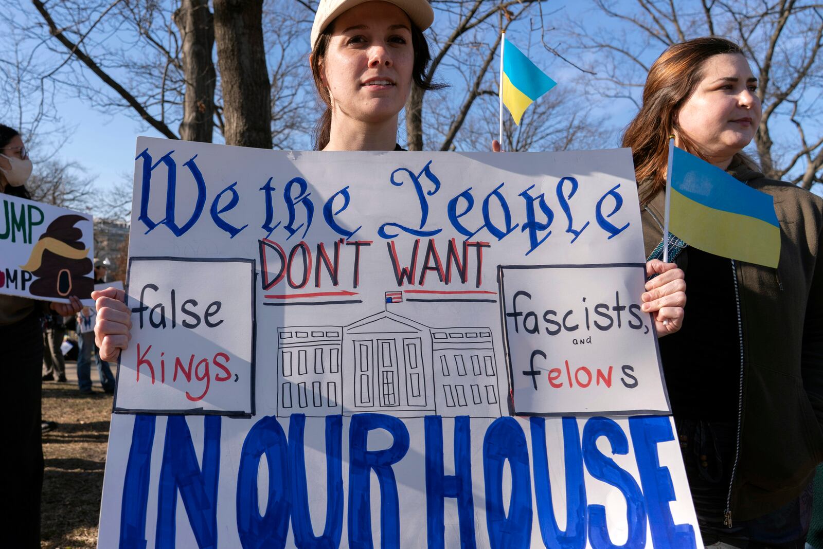 Demonstrators protest near the U.S. Capitol ahead of President Donald Trump address to a joint session of Congress in Washington, Tuesday, March 4, 2025. (AP Photo/Jose Luis Magana)