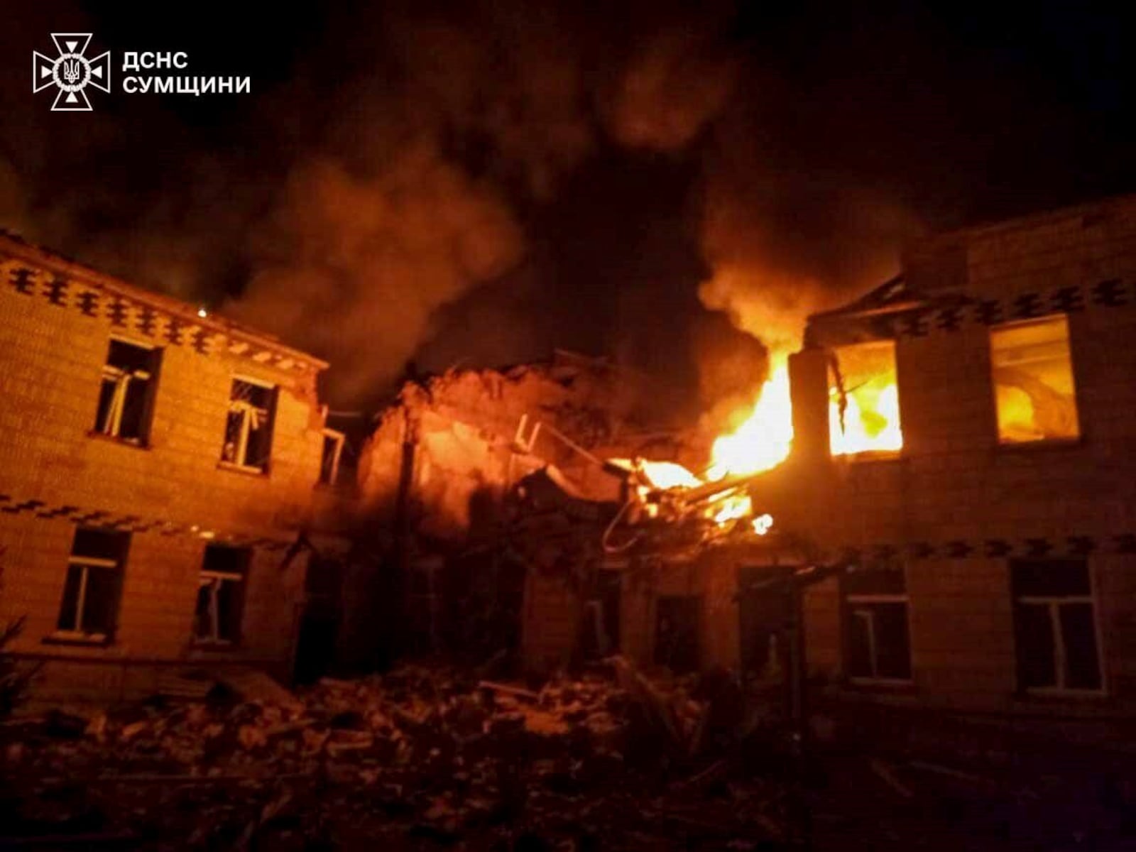 In this photo provided by the Ukrainian Emergency Service on Wednesday, March 19, 2025, flames of fire and smoke engulfed the building after a Russian attack in Krasnopillia, Sumy region, Ukraine. (Ukrainian Emergency Service via AP)