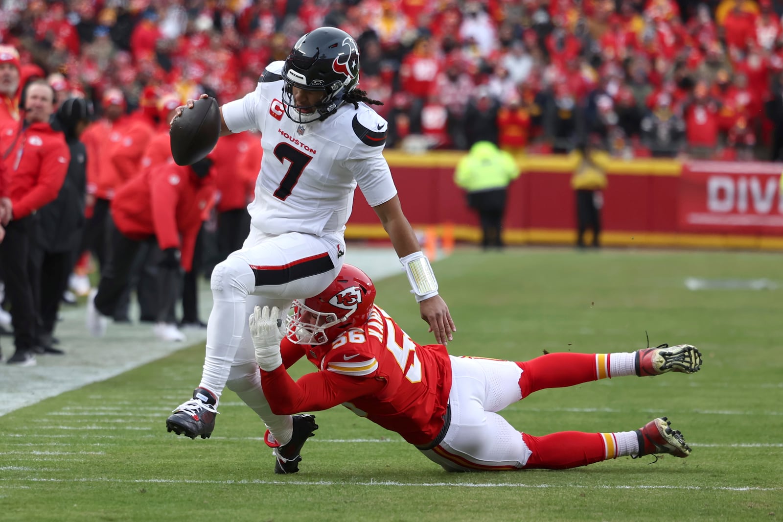 Houston Texans quarterback C.J. Stroud (7) runs with the ball as Kansas City Chiefs defensive end George Karlaftis defends during the first half of an NFL football AFC divisional playoff game Saturday, Jan. 18, 2025, in Kansas City, Mo. (AP Photo/Travis Heying)