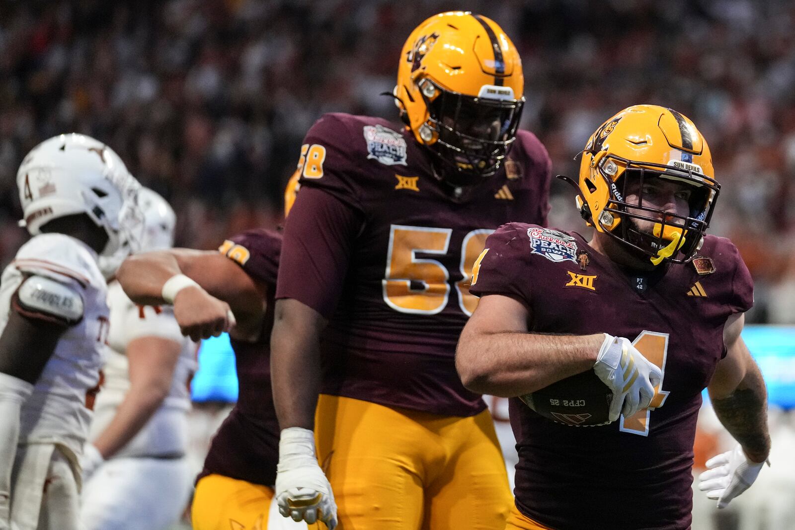 Arizona State running back Cam Skattebo (4) runs into the end zone for a touchdown against Texas during the second half in the quarterfinals of a College Football Playoff game, Wednesday, Jan. 1, 2025, in Atlanta. (AP Photo/Brynn Anderson)