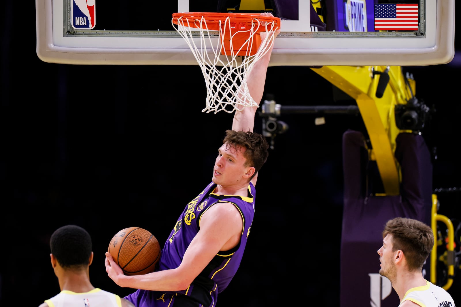 Los Angeles Lakers guard Dalton Knecht dunks during the first half of an Emirates NBA Cup basketball game agaianst the Utah Jazz, Tuesday, Nov. 19, 2024, in Los Angeles. (AP Photo/Etienne Laurent)