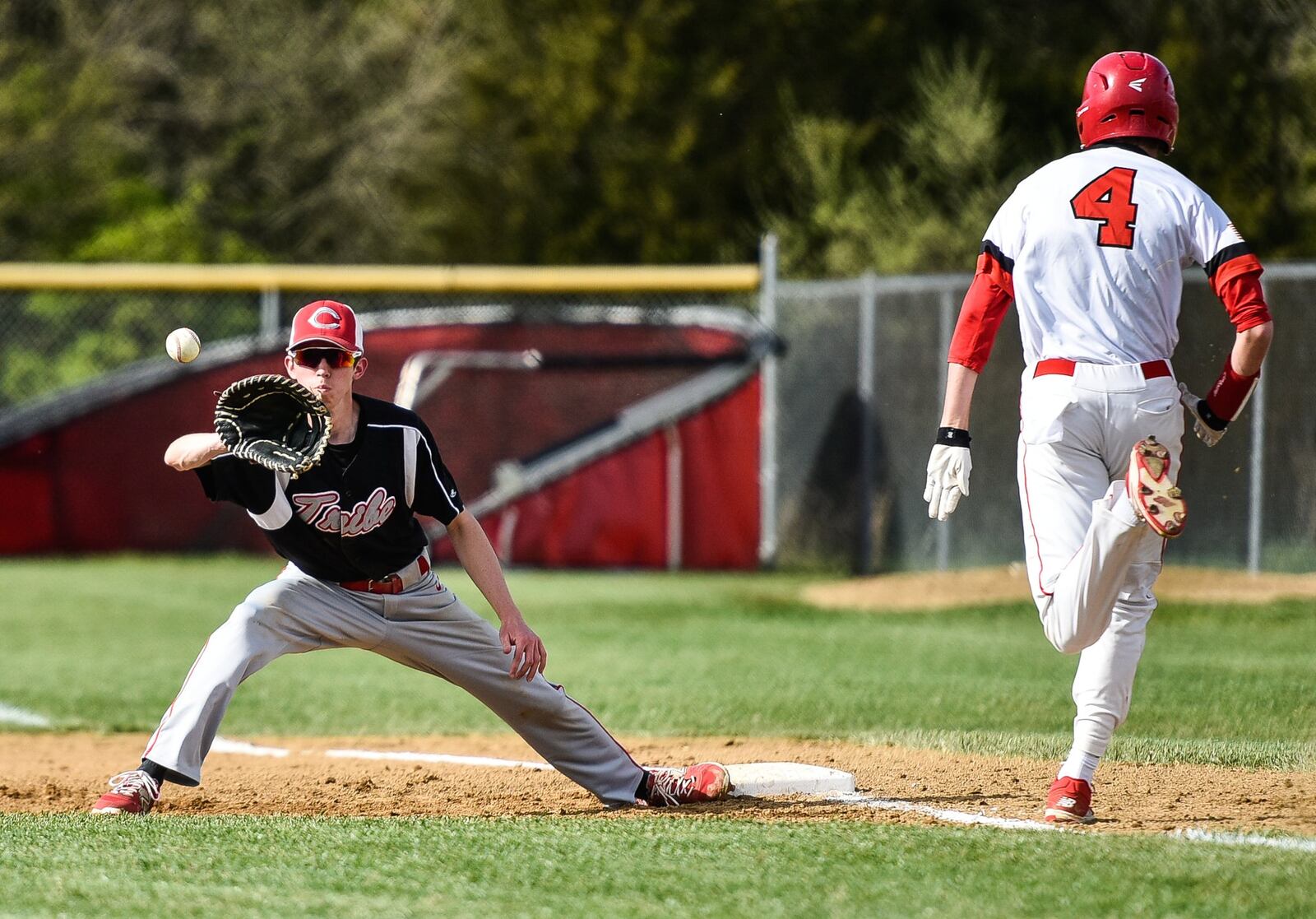 Carlisle’s Caleb Stewart stretches to get Madison’s Jake Edwards out at first base during Thursday’s game in Madison Township. NICK GRAHAM/STAFF