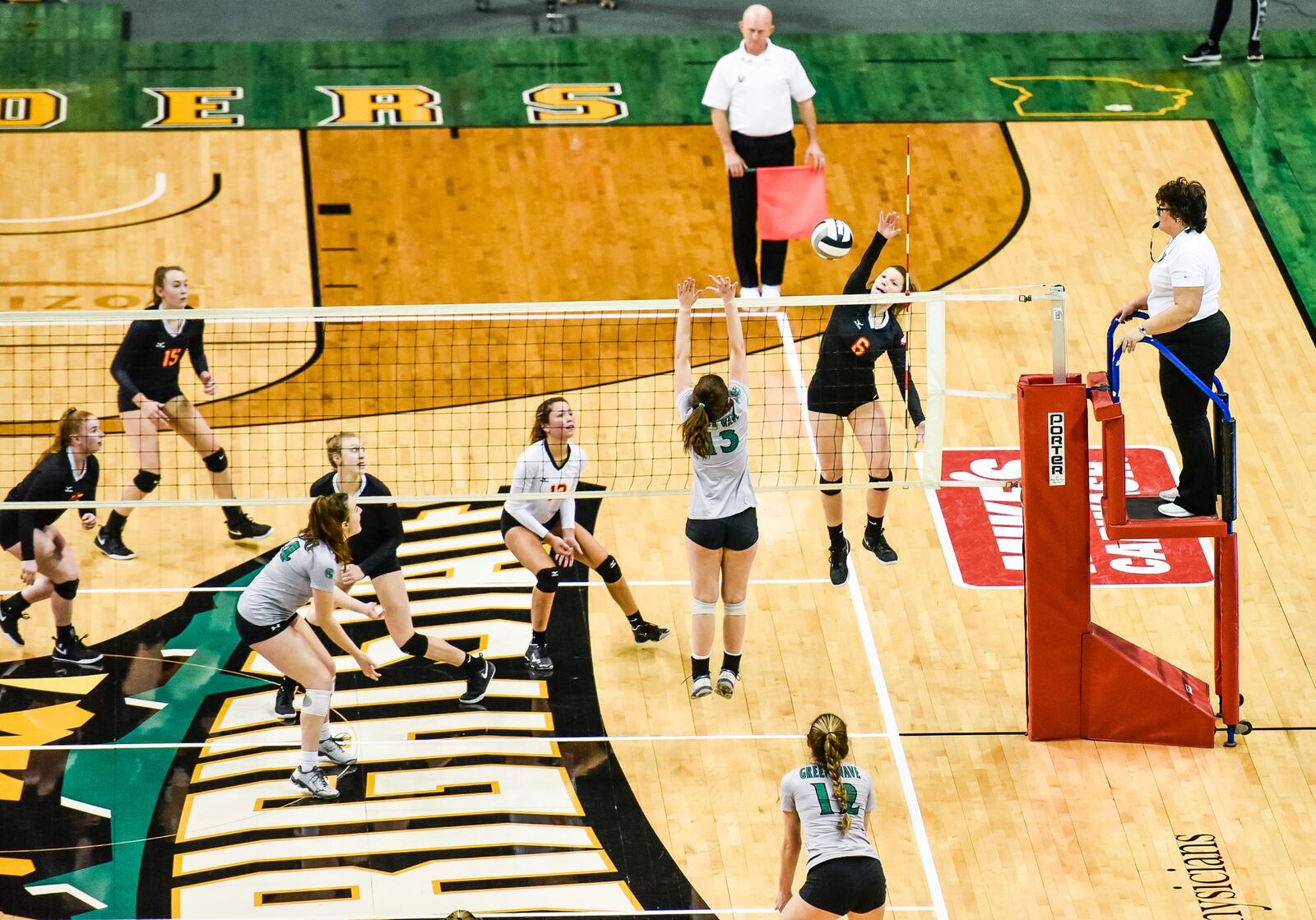 Fenwick’s Grace Dinkelaker (6) goes high for a shot during Friday’s Division II state volleyball semifinal against Parma Heights Holy Name at Wright State University’s Nutter Center. NICK GRAHAM/STAFF