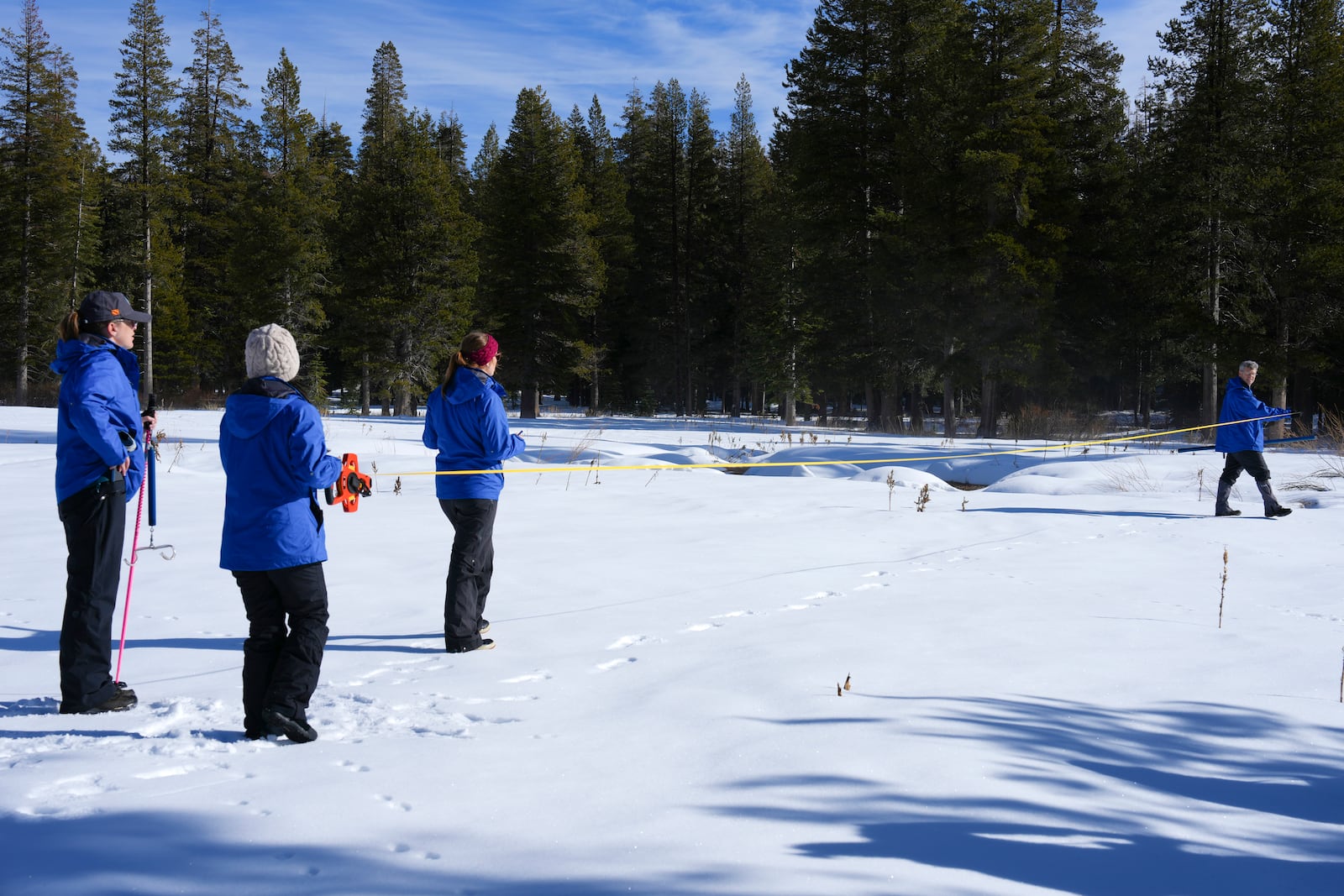 Engineers from the California Department of Water Resources, conduct the first snow survey of the season to assess how much water the state might have come spring and summer at Phillips Station on Thursday, Jan. 2, 2025. (AP Photo/Brooke Hess-Homeier)