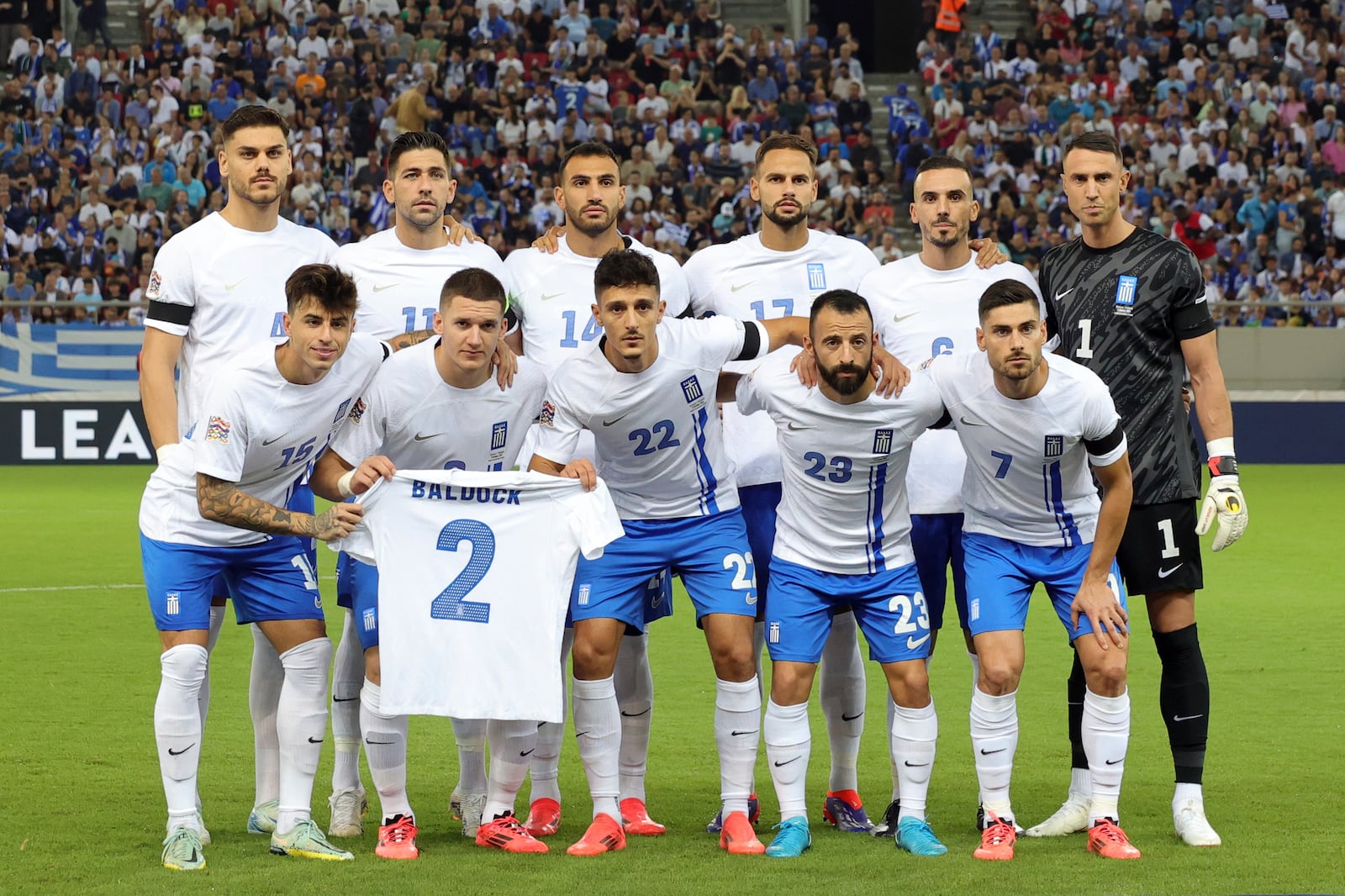 Greece players pose with a shirt of teammate George Baldock who passed away recently. before a Nations League soccer match between Greece and Ireland at the Georgios Karaiskakis Stadium in Piraeus port, near Athens, Sunday, Oct. 13, 2024. (AP Photo/Yorgos Karahalis)