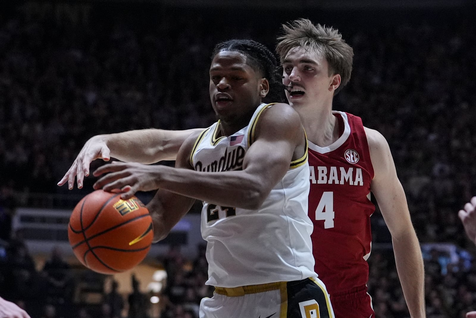 Purdue guard Gicarri Harris (24) is fouled by Alabama forward Grant Nelson (4) during the first half of an NCAA college basketball game in West Lafayette, Ind., Friday, Nov. 15, 2024. (AP Photo/Michael Conroy)