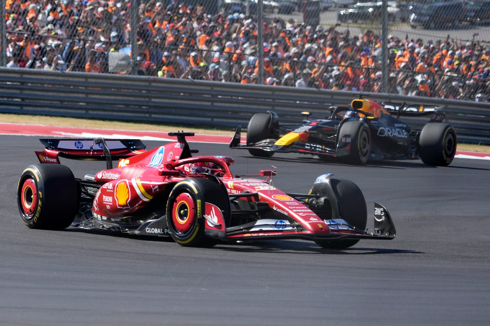 Ferrari driver Charles Leclerc, of Monaco, leads Red Bull driver Max Verstappen, of the Netherlands, through a turn during the U.S. Grand Prix auto race at Circuit of the Americas, Sunday, Oct. 20, 2024, in Austin, Texas. (AP Photo/Eric Gay)