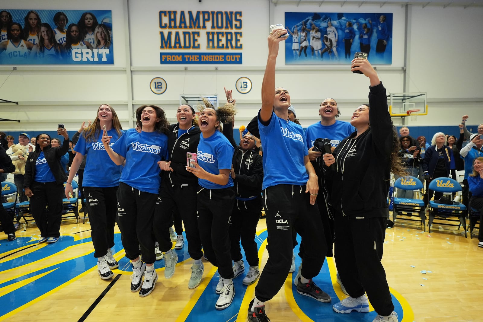 UCLA players react after being revealed as the No. 1 overall seed in the women's NCAA basketball tournament at the Selection Sunday watch party in Los Angeles Sunday, March 16, 2025. (AP Photo/Jae C. Hong)