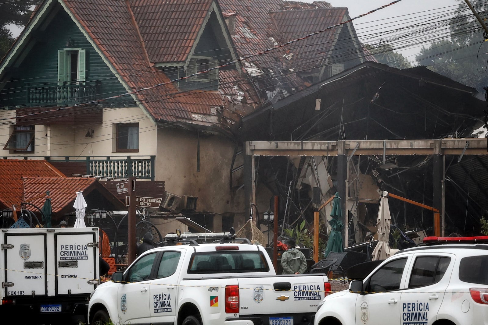 Police cordon off houses that were hit by a plane in Gramado, Rio Grande do Sul state, Brazil, Sunday, Dec. 22, 2024. (AP Photo/Mateus Bruxel, Agência RBS)