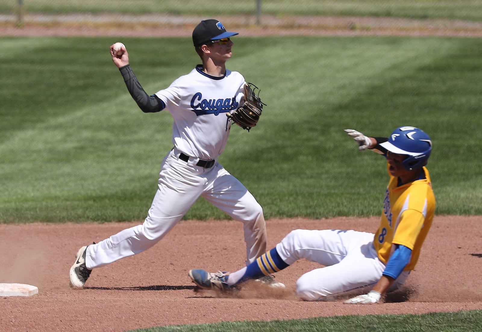 Russia’s Daniel Kearns is out at second base as Cincinnati Christian shortstop Alex Johnson throws to first for a double play during Thursday’s Division IV regional semifinal at Carleton Davidson Stadium in Springfield. BILL LACKEY/STAFF