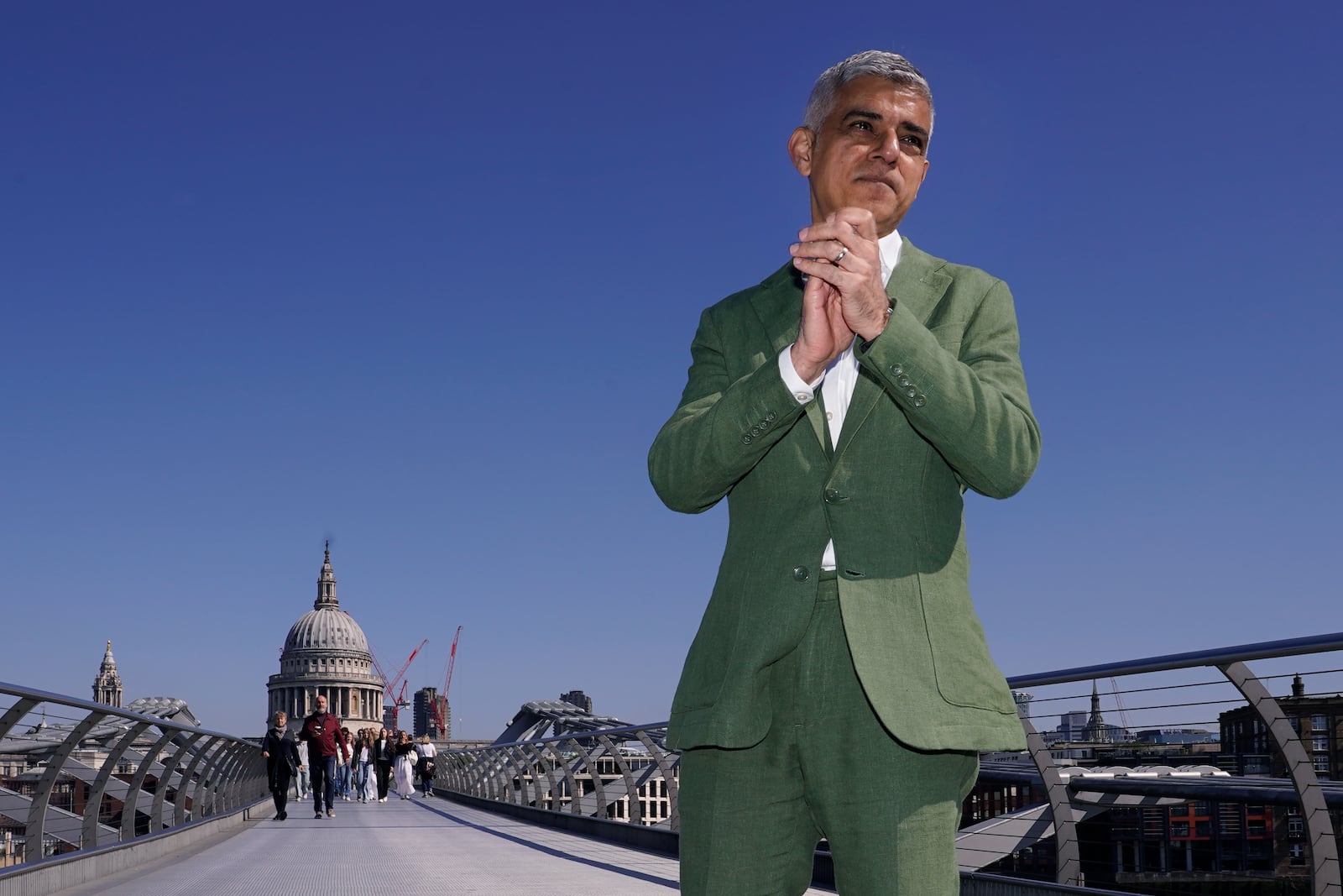 FILE - The newly re-elected Labour Party Mayor of London Sadiq Khan, poses for the media on the Millennium Bridge before his swearing in ceremony in London, Tuesday, May 7, 2024. (AP Photo/Alberto Pezzali, File)