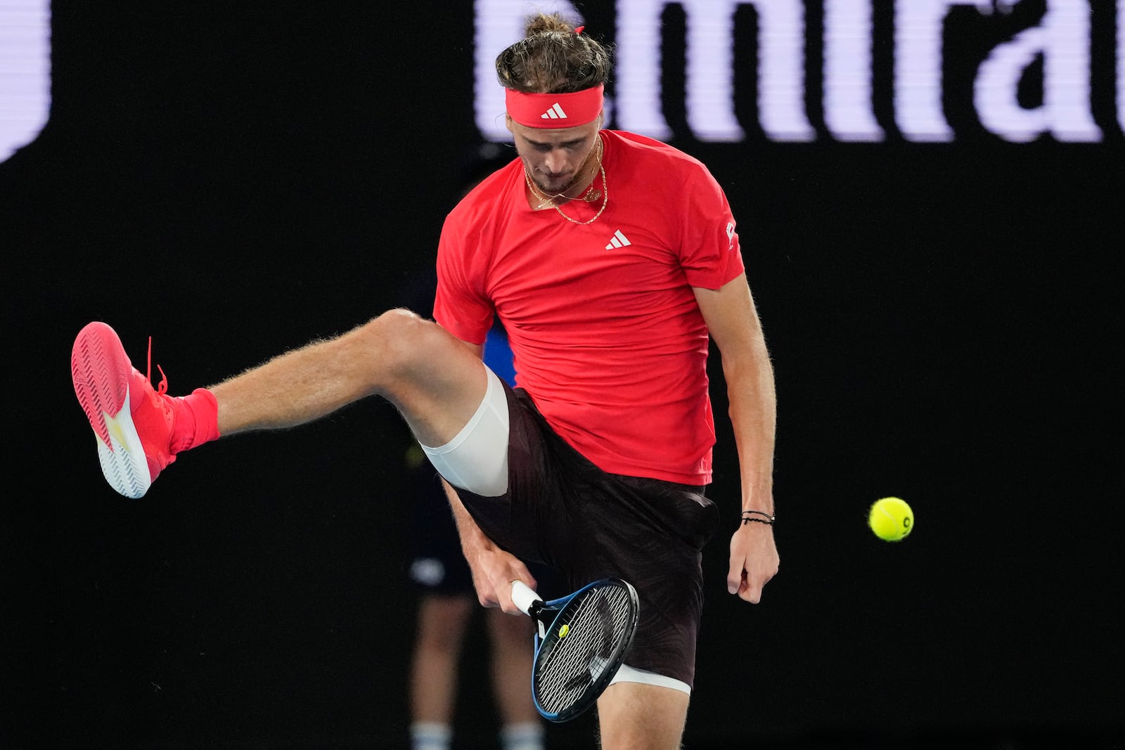 Alexander Zverev of Germany plays shot back between his legs to Lucas Pouille of France during their first round match at the Australian Open tennis championship in Melbourne, Australia, Sunday, Jan. 12, 2025. (AP Photo/Vincent Thian)