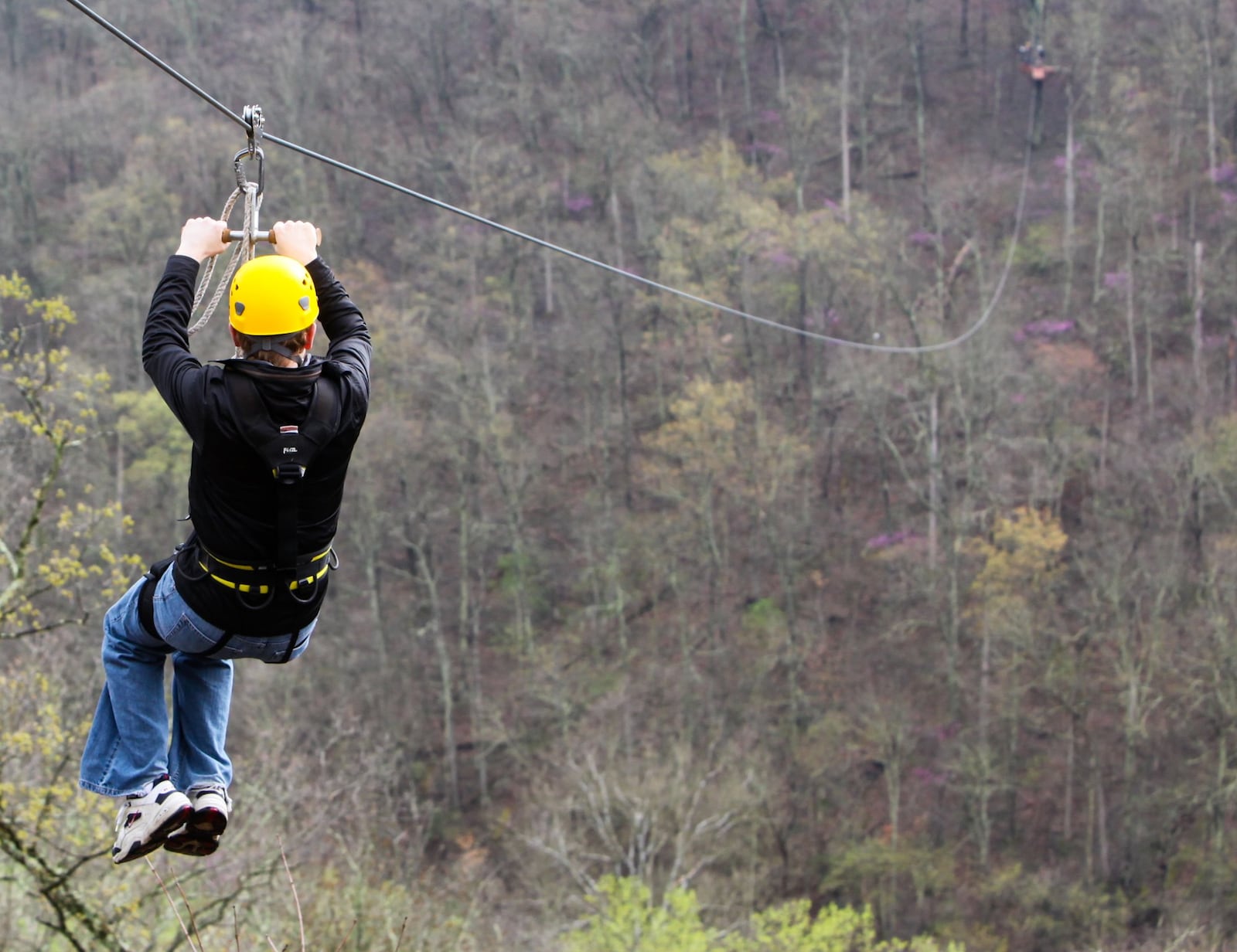 Riders enjoy views of the Little Miami River on zip lines at Ozone Zipline Adventures at YMCA Camp Kern in Oregonia. Greg Lynch/ Staff