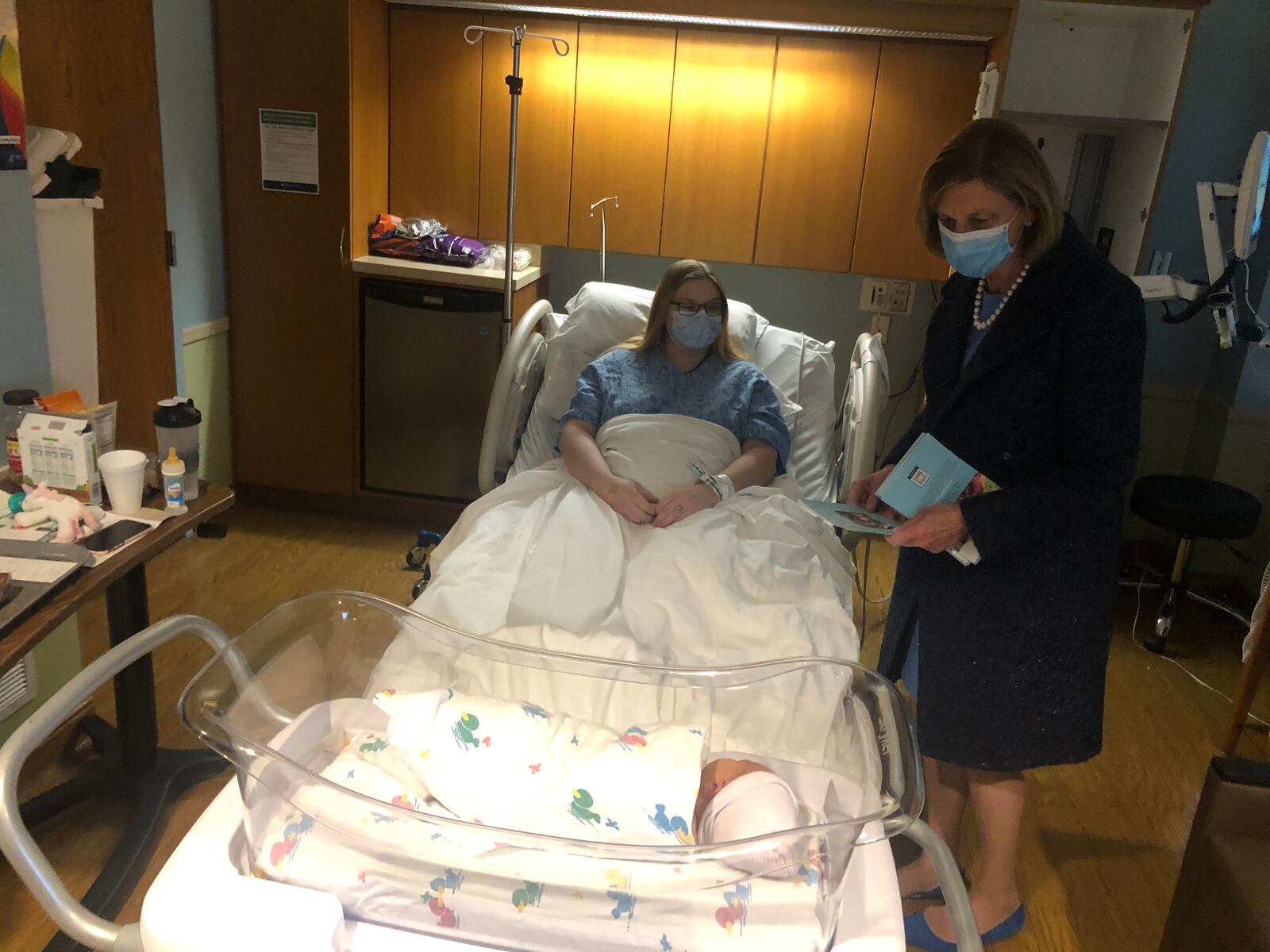 Ohio First Lady Fran DeWine visits with first-time mother Emily Walker Monday morning at Kettering Health Hamilton. DeWine toured the hospital's birthing center and talked about Ohio's Imagination Library. RICK McCRABB/STAFF