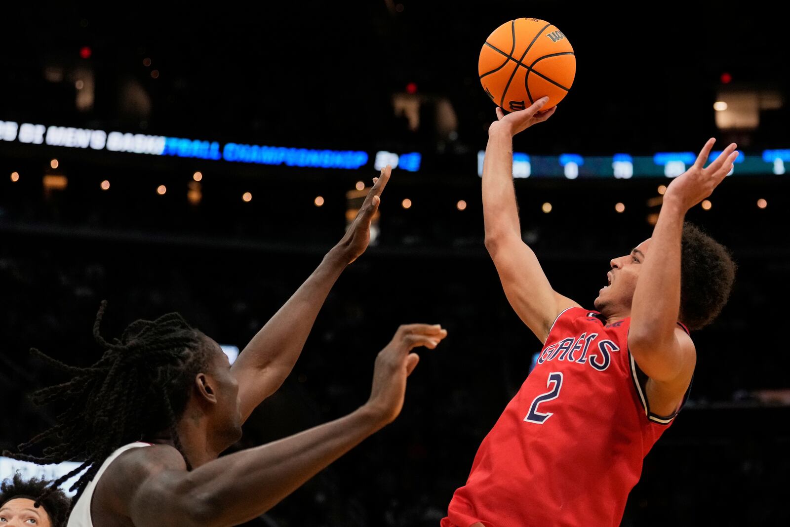 Saint Mary's guard Jordan Ross (2) shoots over Alabama center Clifford Omoruyi, left, in the second half in the second round of the NCAA college basketball tournament, Sunday, March 23, 2025, in Cleveland. (AP Photo/Sue Ogrocki)