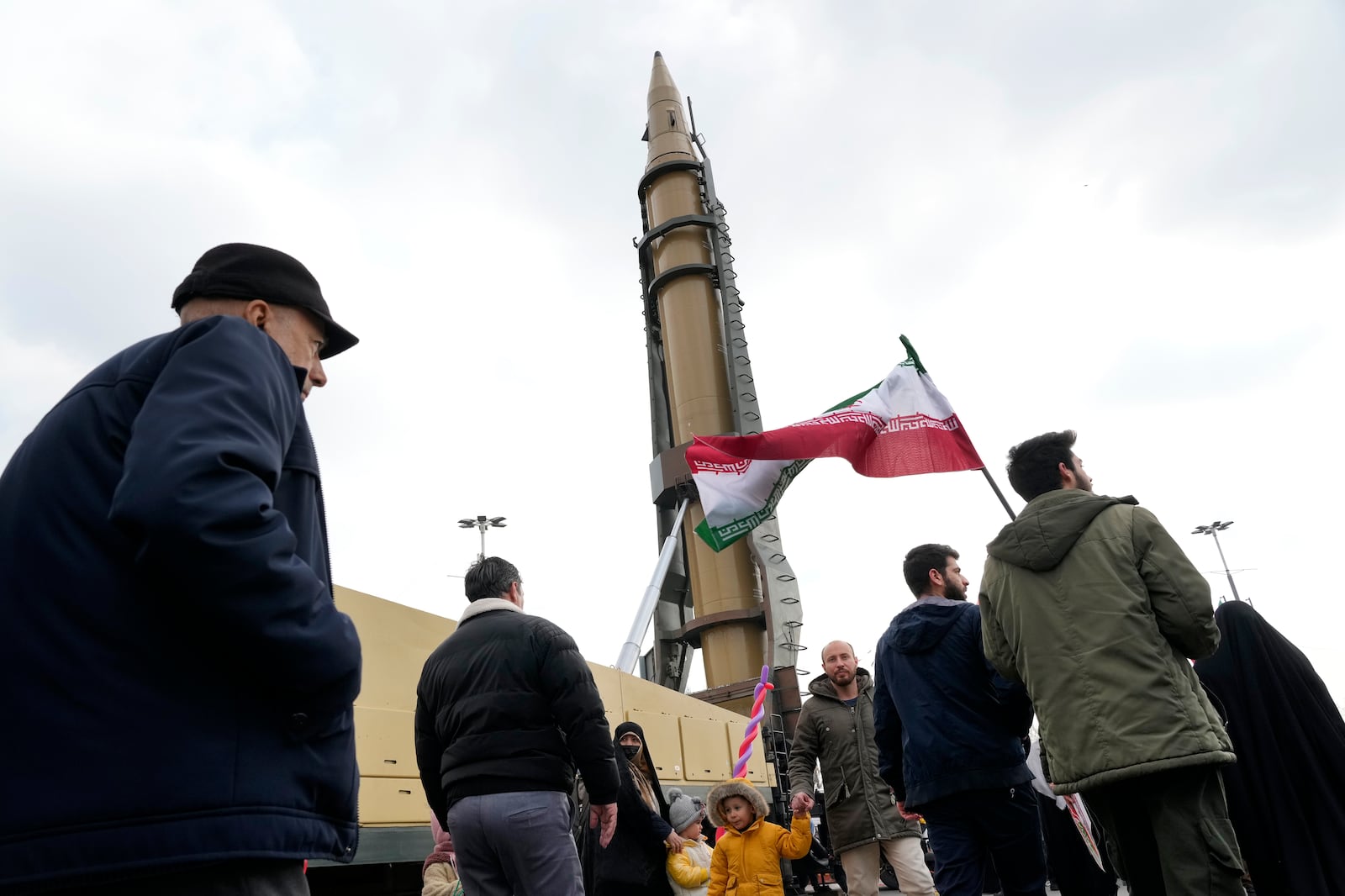 Iranian demonstrators march next to a domestically-built missile during a rally commemorating anniversary of 1979 Islamic Revolution that toppled the late pro-U.S. Shah Mohammad Reza Pahlavi and brought Islamic clerics to power, in Tehran, Iran, Monday, Feb. 10, 2025. (AP Photo/Vahid Salemi)