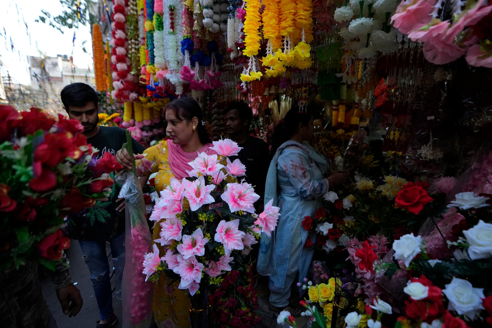 People shop on the eve of Diwali, the Hindu festival of lights, in Jammu, India, Wednesday, Oct. 30, 2024.Diwali is one of Hinduism's most important festivals, dedicated to the worship of the goddess of wealth Lakshmi. (AP Photo/Channi Anand)