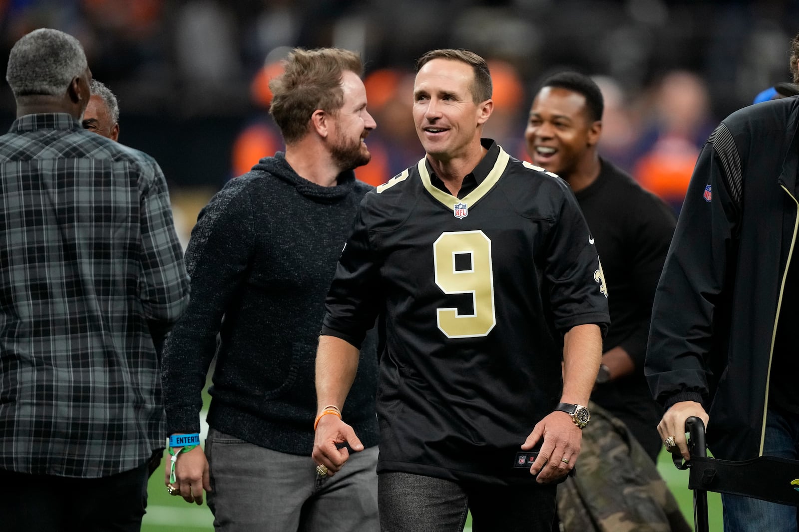 Former New Orleans Saints quarterback Drew Brews walks on the field before an NFL football game between the Saints and the Denver Broncos, Thursday, Oct. 17, 2024, in New Orleans. (AP Photo/Gerald Herbert)