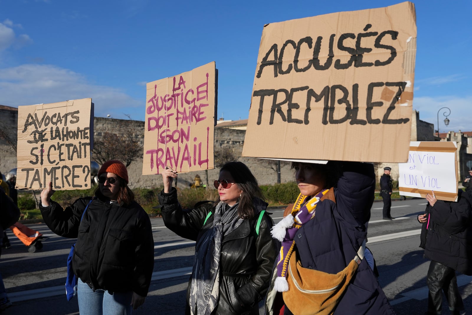 FILE -Activists hold posters during a women's rights demonstration, Dec. 14, 2024 in Avignon, southern France, where the trial of dozens of men accused of raping Gisèle Pelicot while she was drugged and rendered unconscious by her husband is taking place. (AP Photo/Aurelien Morissard), File)