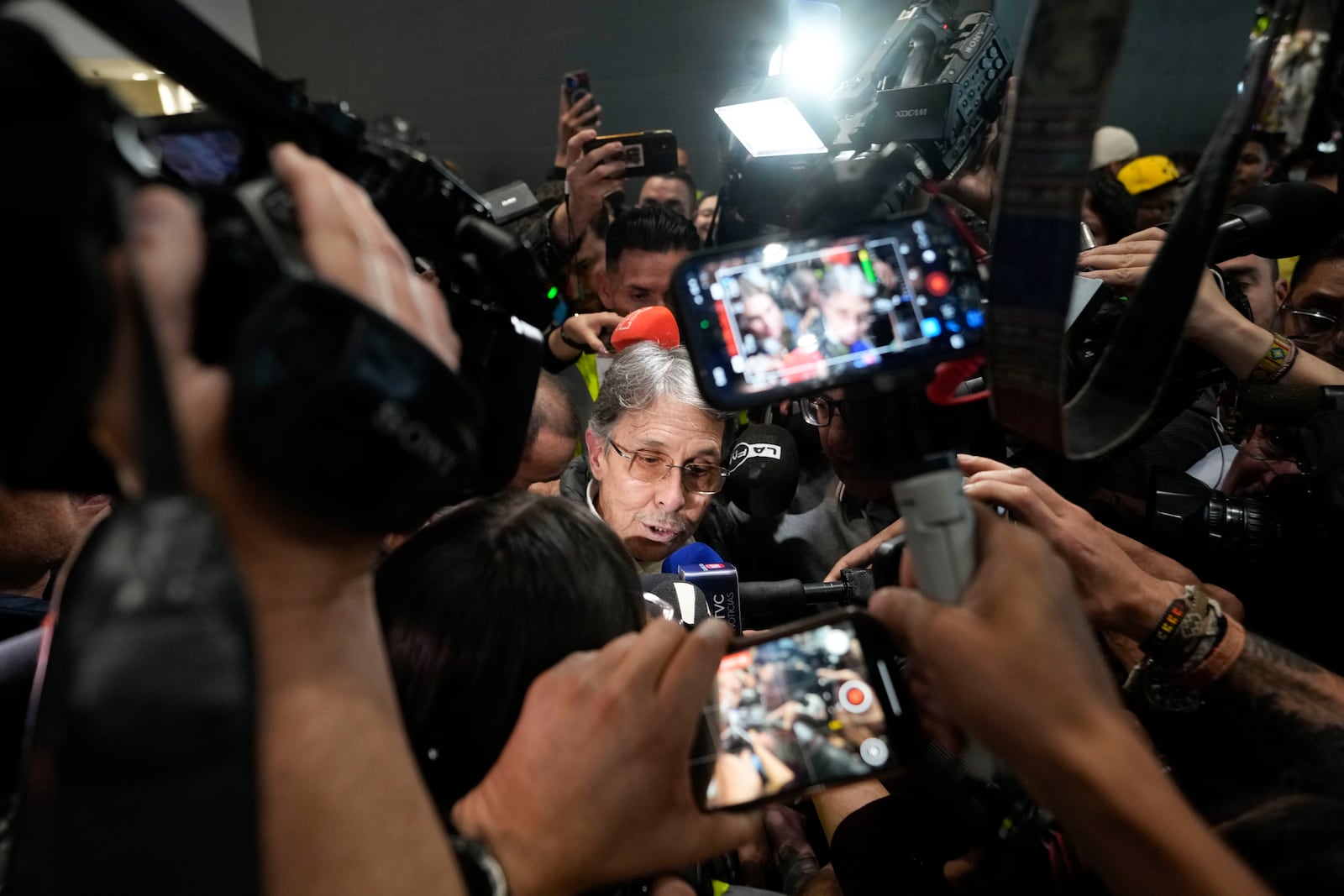 Fabio Ochoa, a former member of Cartel of Medellin, speaks to the media upon his arrival at El Dorado airport, after being deported from the United States, in Bogota, Colombia, Monday, Dec. 23, 2024. (AP Photo/Fernando Vergara)