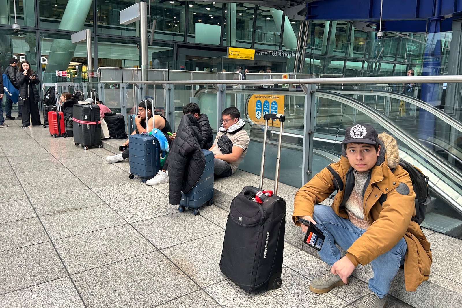 Travellers are waiting as Britain's Heathrow Airport has closed for the full day Friday after an electrical substation fire knocked out its power, disrupting flights for hundreds of thousands of passengers at one of Europe's biggest travel hubs in London, Friday, March 21, 2025.(AP Photo/Kin Cheung)