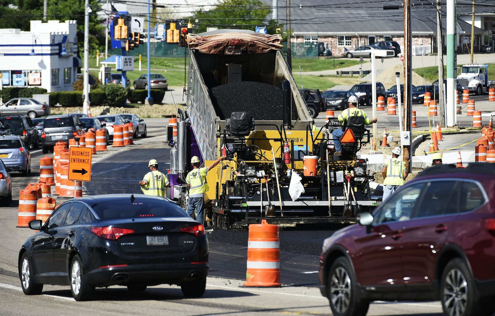 Crews pave a section of South Gilmore Road at Ohio 4 on Thursday, Aug. 25 in Fairfield.