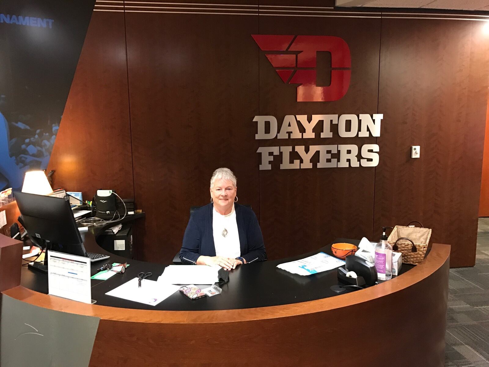 Linda Waltz at the front desk of the Dayton Flyers women’s basketball offices. CONTRIBUTED