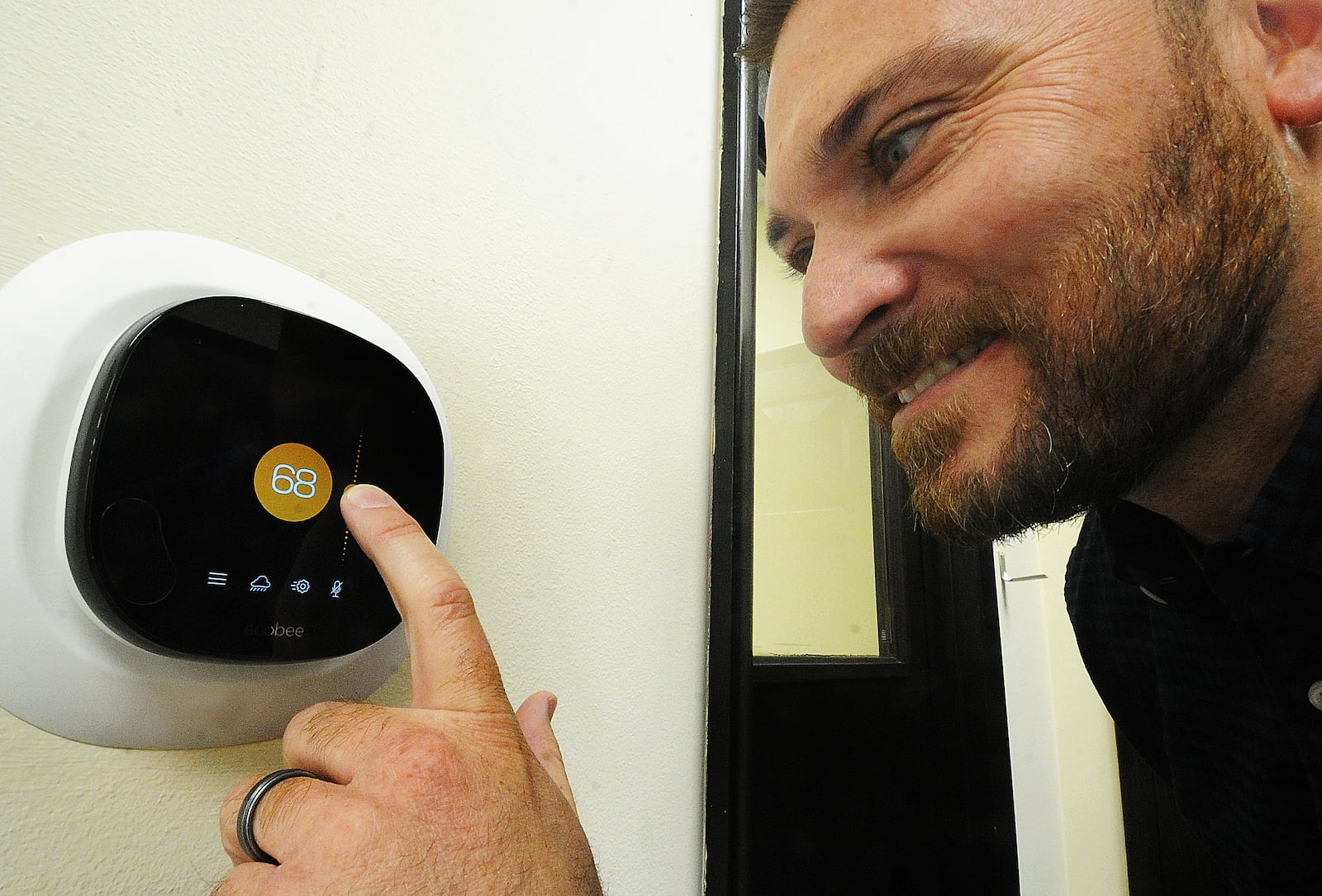 Nick Lamb, owner of Butler Heating and Air Conditioning, stands next to a programmable thermostat on Oct. 18, 2022. He says they are a good way to save on energy in your home. MARSHALL GORBY\STAFF