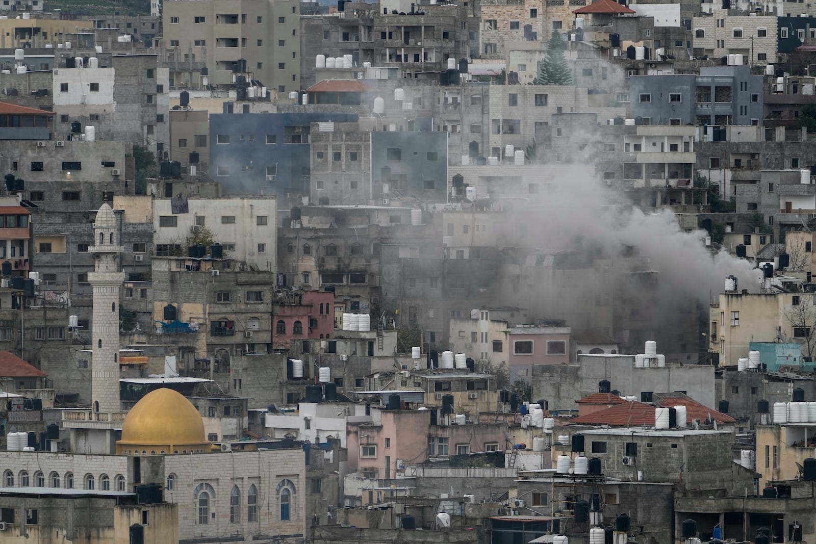 Smoke rises during an Israeli army operation in the West Bank refugee camp of Nur Shams, Tulkarem, on Tuesday, Feb. 11, 2025. (AP Photo/Majdi Mohammed)