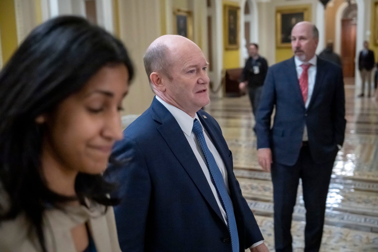 Sen. Chris Coons, D-Del., walks from the Senate chamber at the Capitol in Washington, Friday, March 14, 2025. (AP Photo/Ben Curtis)