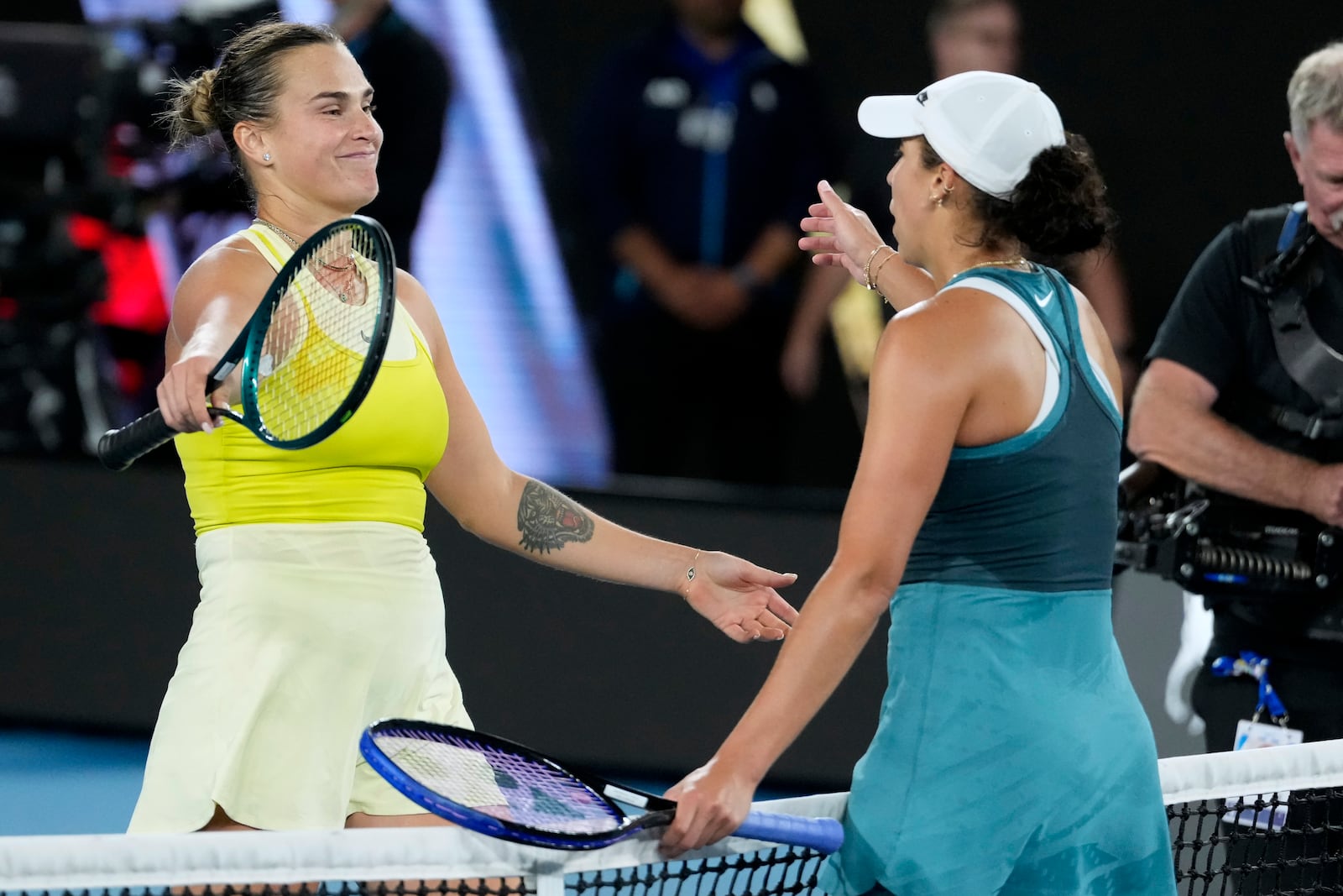 Madison Keys, right, of the U.S. is congratulated by Aryna Sabalenka, left, of Belarus following the women's singles final at the Australian Open tennis championship in Melbourne, Australia, Saturday, Jan. 25, 2025. (AP Photo/Asanka Brendon Ratnayake)