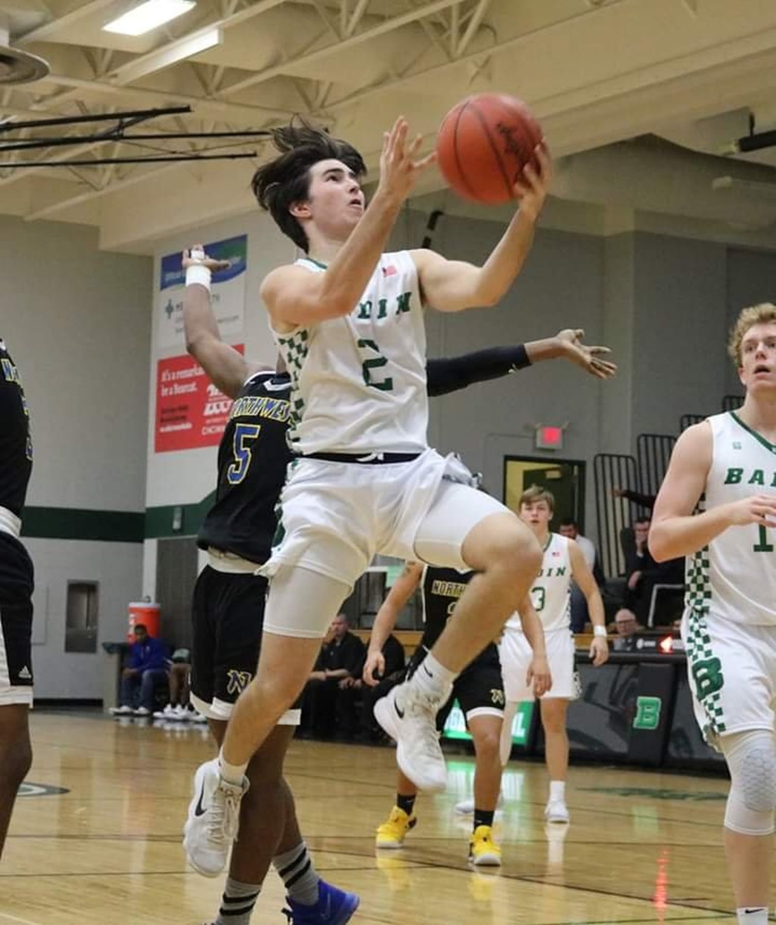 Badin’s Seth Hargis (2) drives past Northwest’s Dae’Mon Cherry (5) during Tuesday night’s game at Mulcahey Gym in Hamilton. Badin won 70-52. CONTRIBUTED PHOTO BY TERRI ADAMS