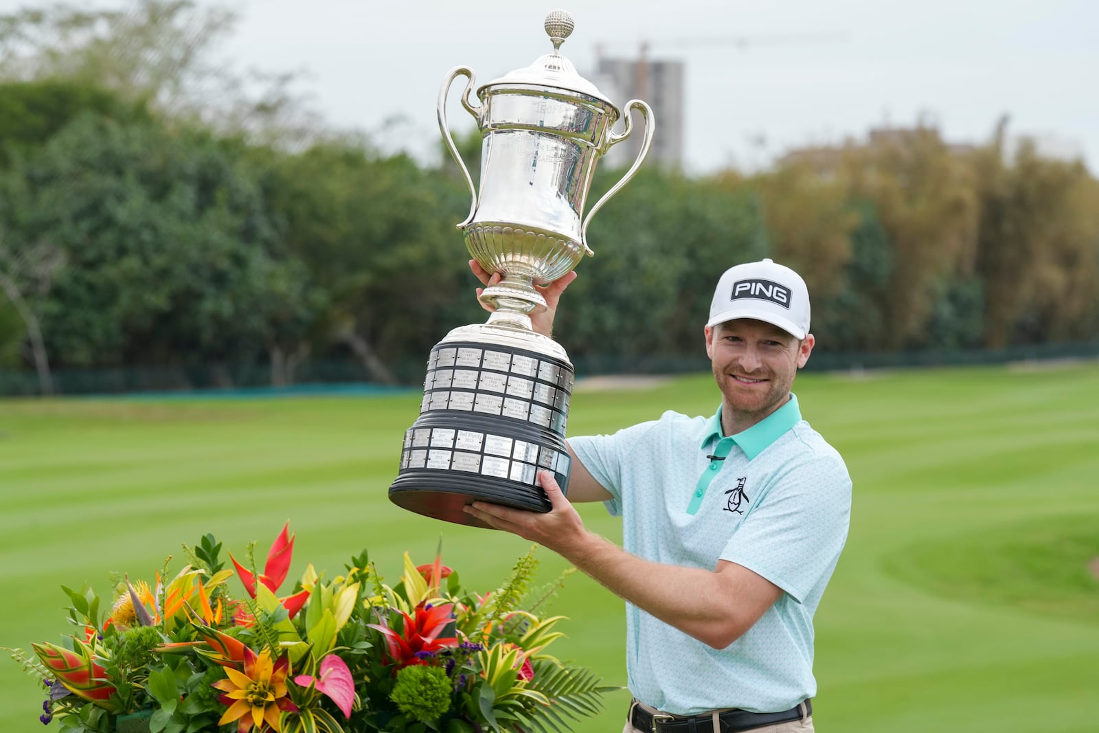 Brian Campbell, of the United States, holds the championship trophy after the final round of the Mexico Open golf tournament in Puerto Vallarta, Mexico, Sunday, Feb. 23, 2025. (AP Photo/Fernando Llano)