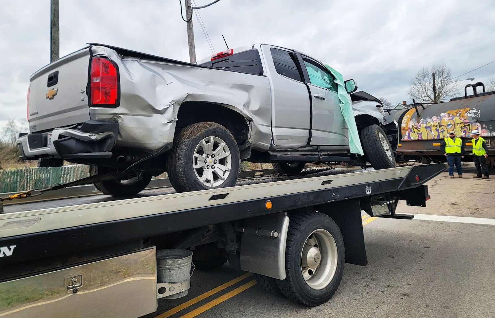 A pickup truck is on the back of a flatbed tow truck after it was struck by a train on Trenton Road in St. Clair Twp. on Tuesday afternoon, March 26, 2024. The passenger was transported by ambulance to an area hospital with minor injuries. The driver was not transported. NICK GRAHAM/STAFF