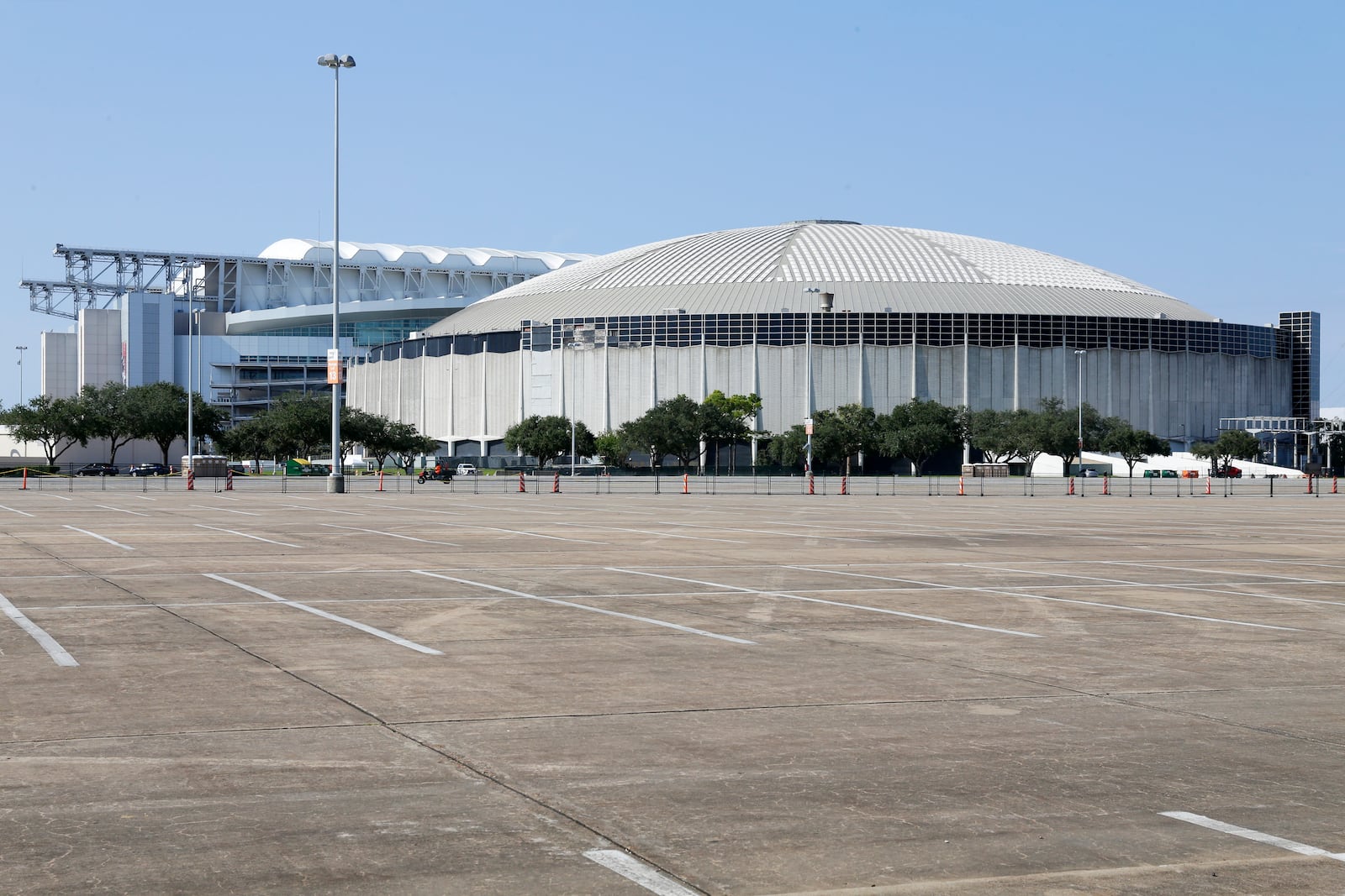 A view looking west of NRG Stadium, left, home to the Houston Texans NFL team, and the now dormant Astrodome, right, in the area now know as NRG Park Wednesday, Nov. 13, 2024, in Houston. The Astrodome Conservancy, a group dedicated to preserving the structure, has proposed a multi-use renovation for the once legendary building. (AP Photo/Michael Wyke)